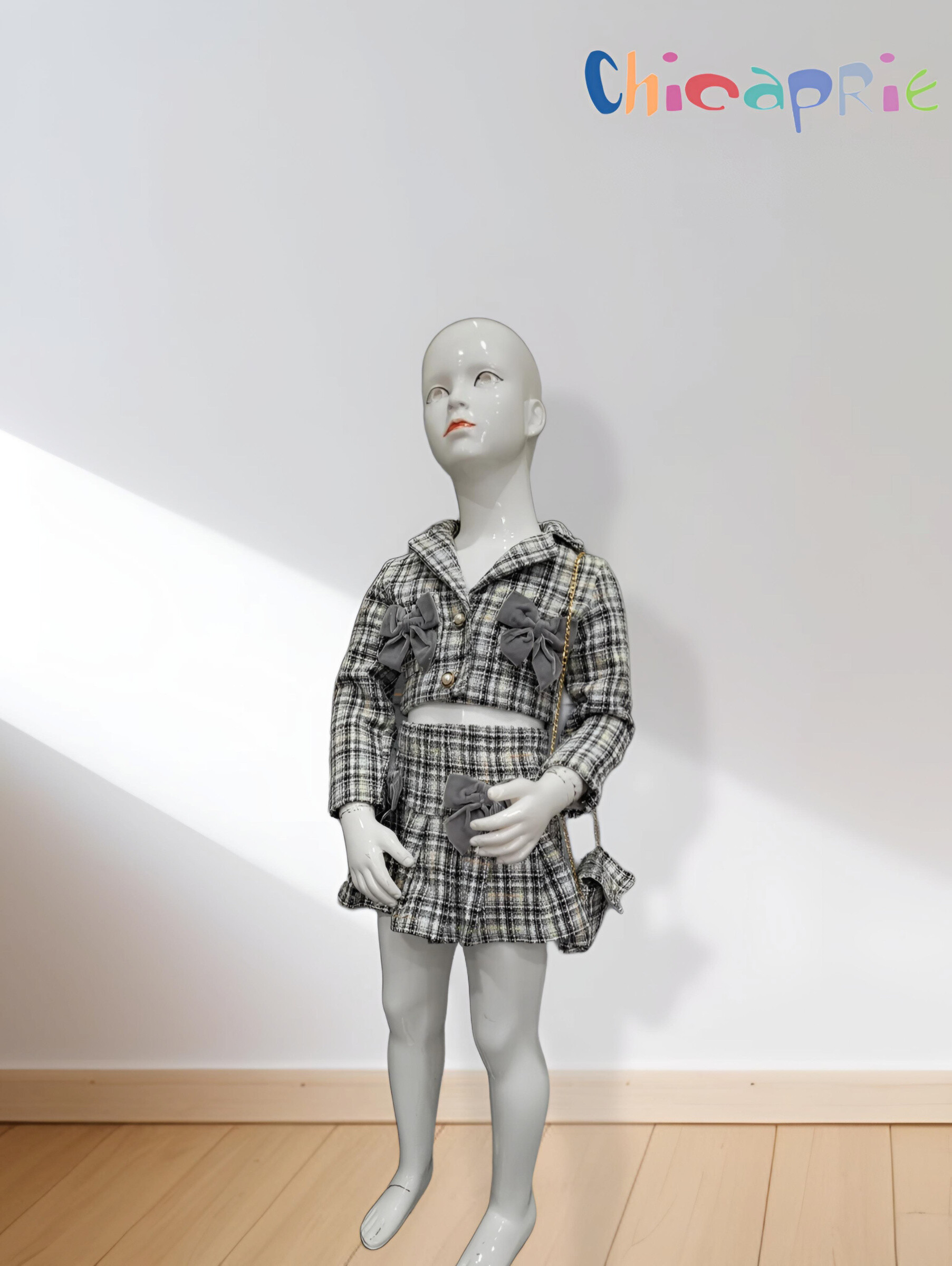 Grossista Chicaprie - Completo giacca e gonna corta in tweed a quadri con fiocchi per bambina