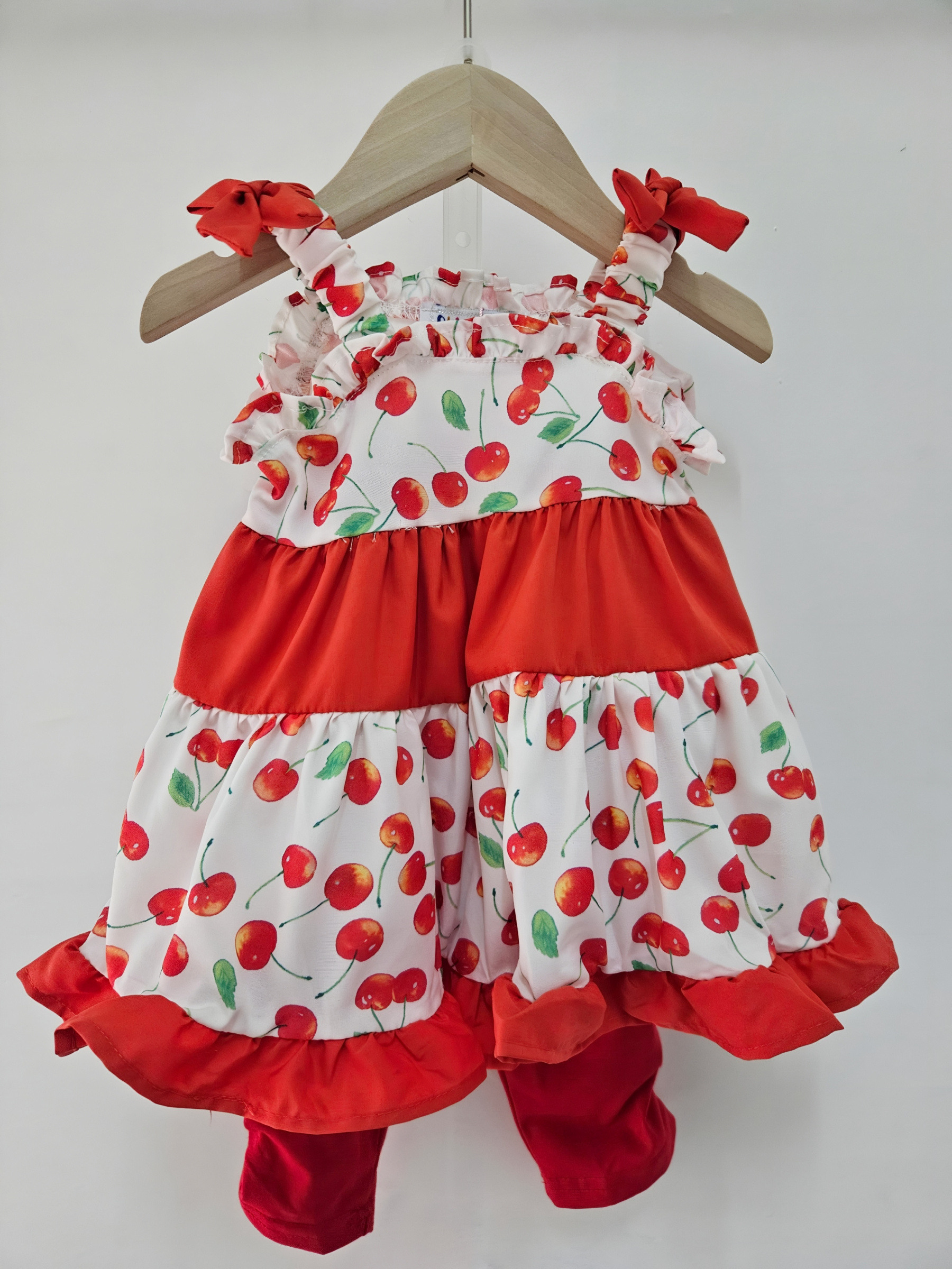 Wholesaler Chicaprie - Baby girl outfit with a cherry and bow print suspender dress and plain leggings