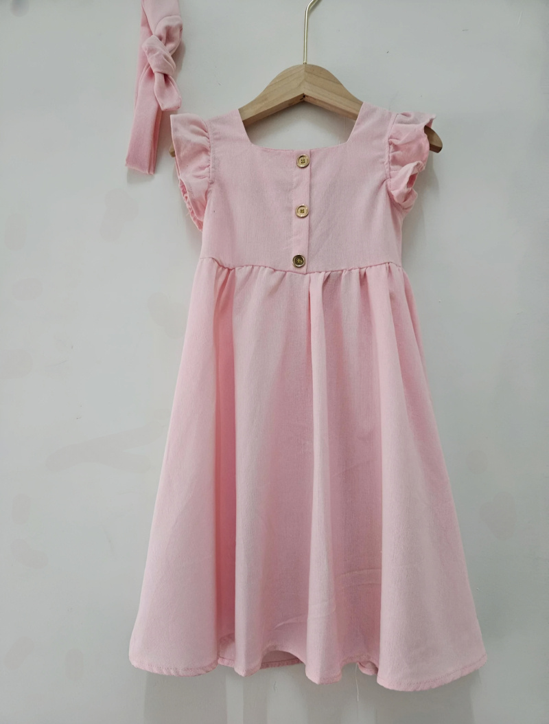 Wholesaler Chicaprie - Flowing, solid-color girl's dress with buttons, ruffles, a headband, and a bow in a bohemian style