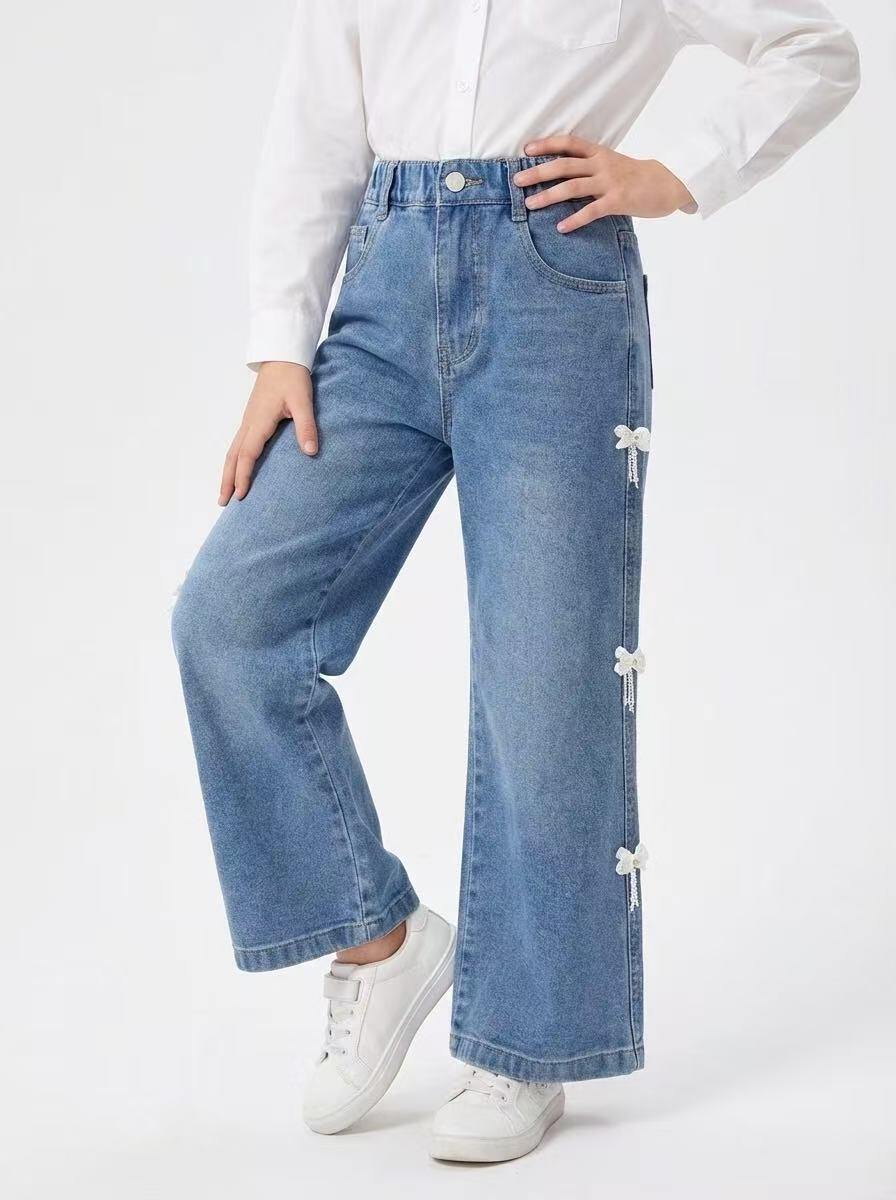 Mayorista Fiona & Co - Vaqueros anchos azules para niña con detalles de lazos