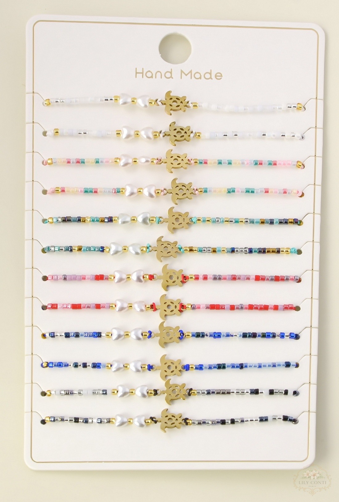 Grossiste LILY CONTI - Lot de 12 bracelets enfant réglables coulissants – motif tortue en acier inoxydable