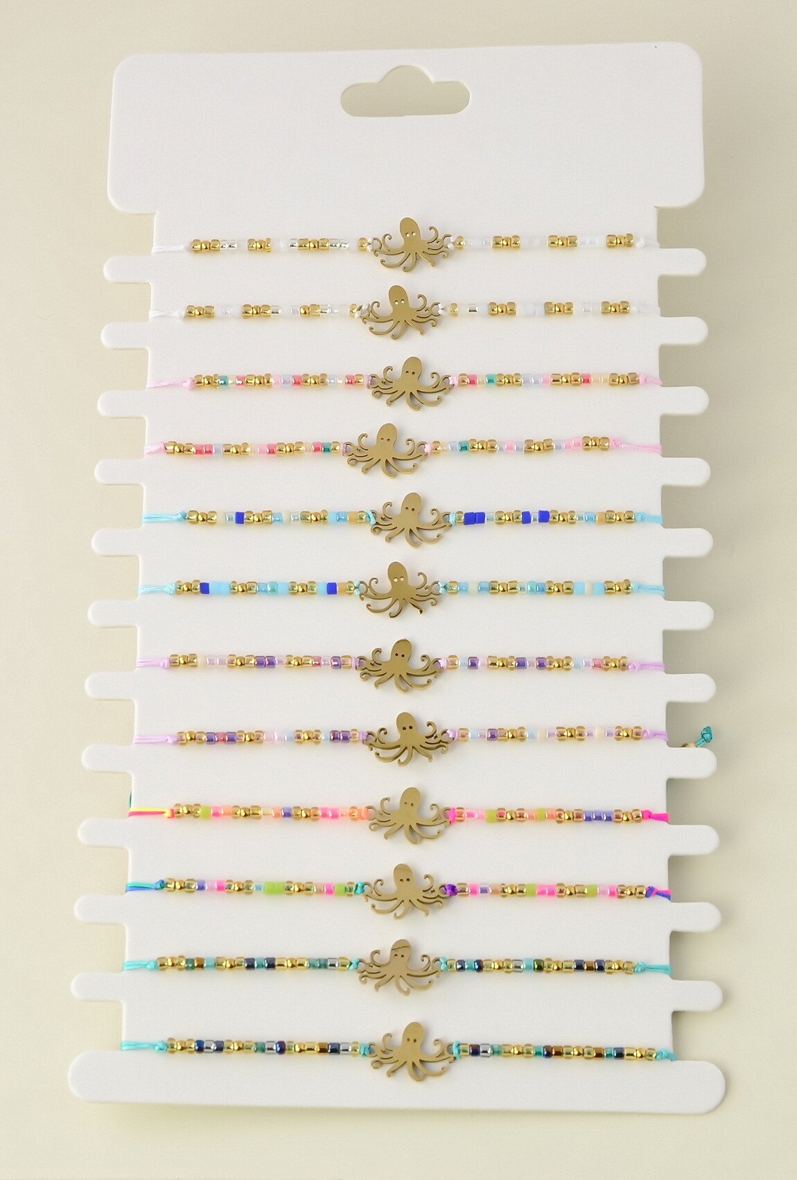 Grossiste LILY CONTI - Lot de 12 bracelets ajustables en acier inoxydable doré et perles rocailles
