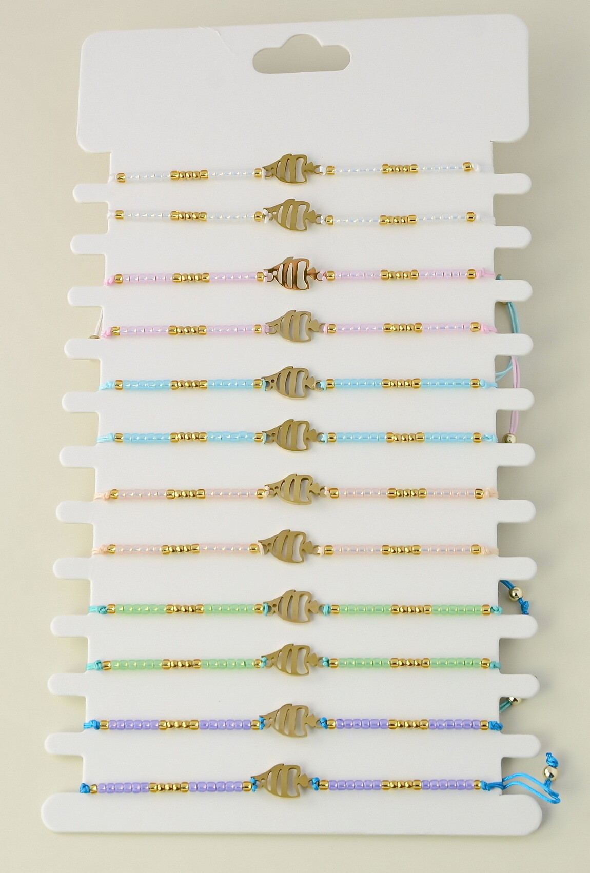 Grossiste LILY CONTI - Lot de 12 bracelets ajustables en acier inoxydable doré et perles rocailles
