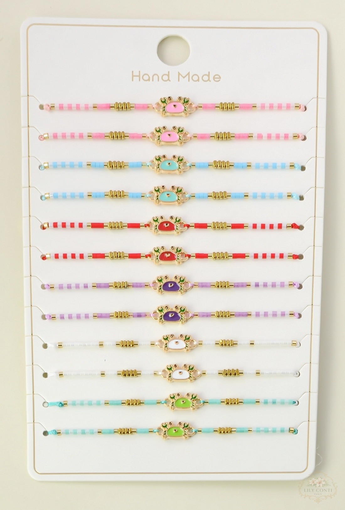 Grossiste LILY CONTI - Lot de 12 bracelets enfant réglables coulissants – motif crabe émaillé