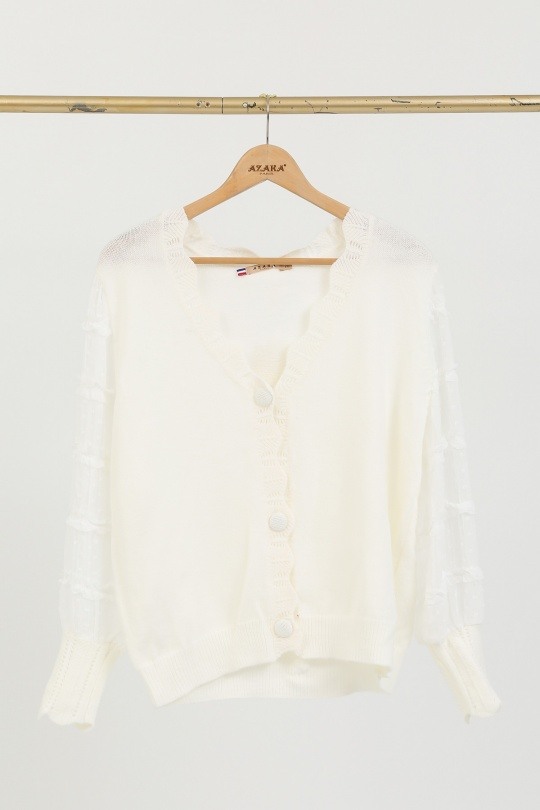 Gilet féminin doux, mi-saison, 50% polyamide, 50% viscose, idéal pour le printemps. Importé de Chine.