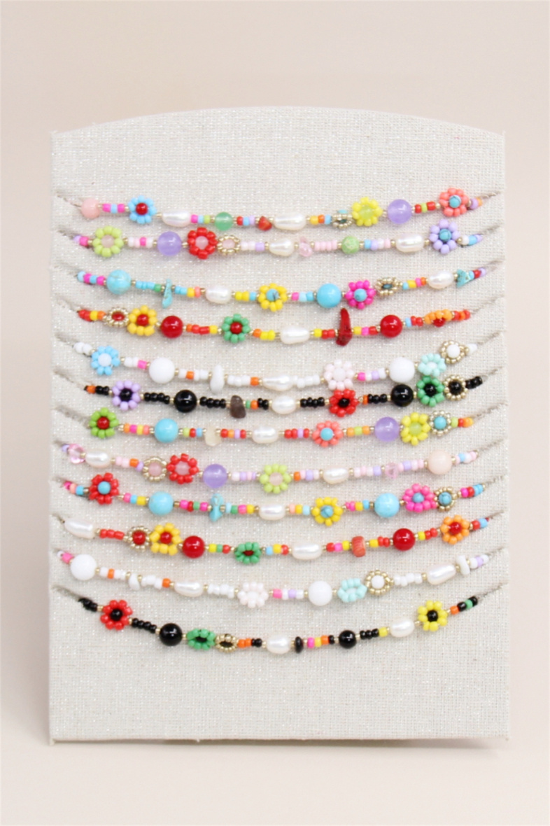 Grossiste Bellissima - Lot de 12 colliers fleur en perle en acier inoxydable avec présentoir
