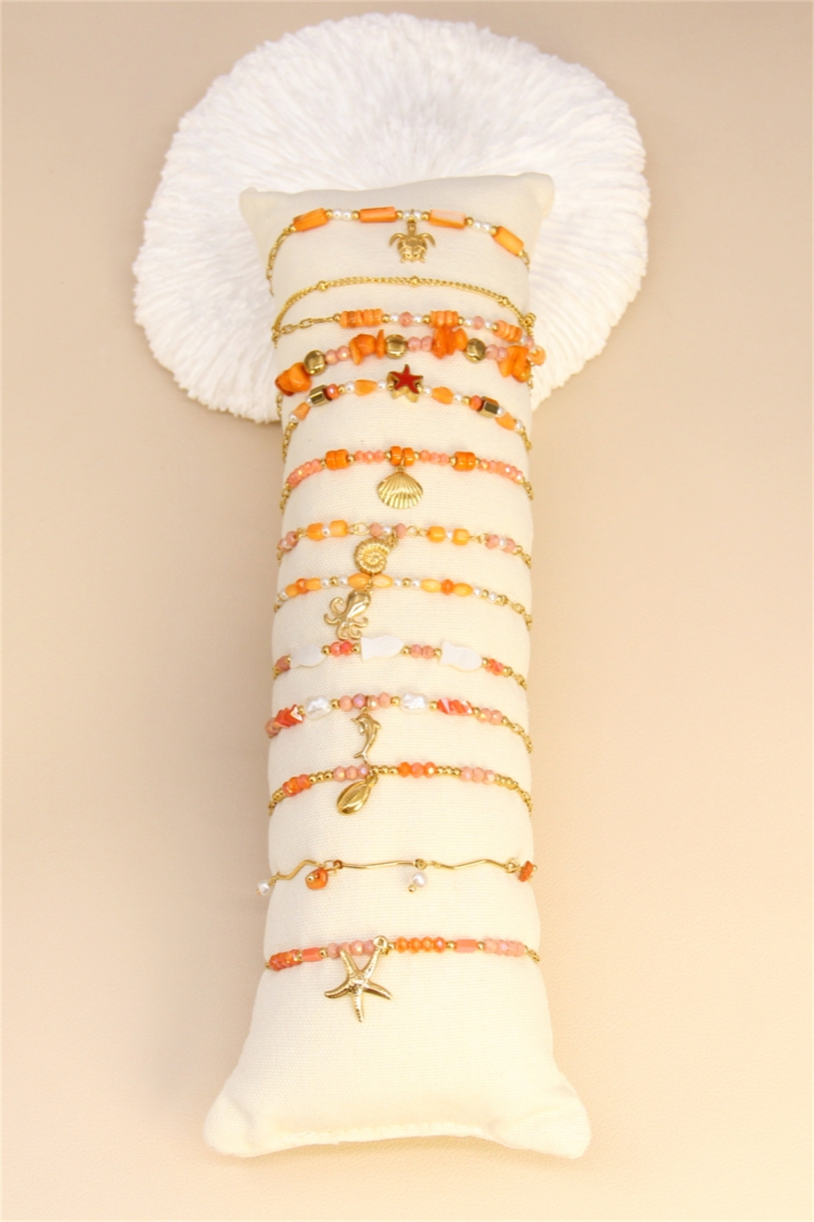 Mayorista Bellissima - Conjunto de 12 Pulseras de Acero Inoxidable - Perlas Naranjas y Charms Dorados - Soporte de Exhibición Incluido