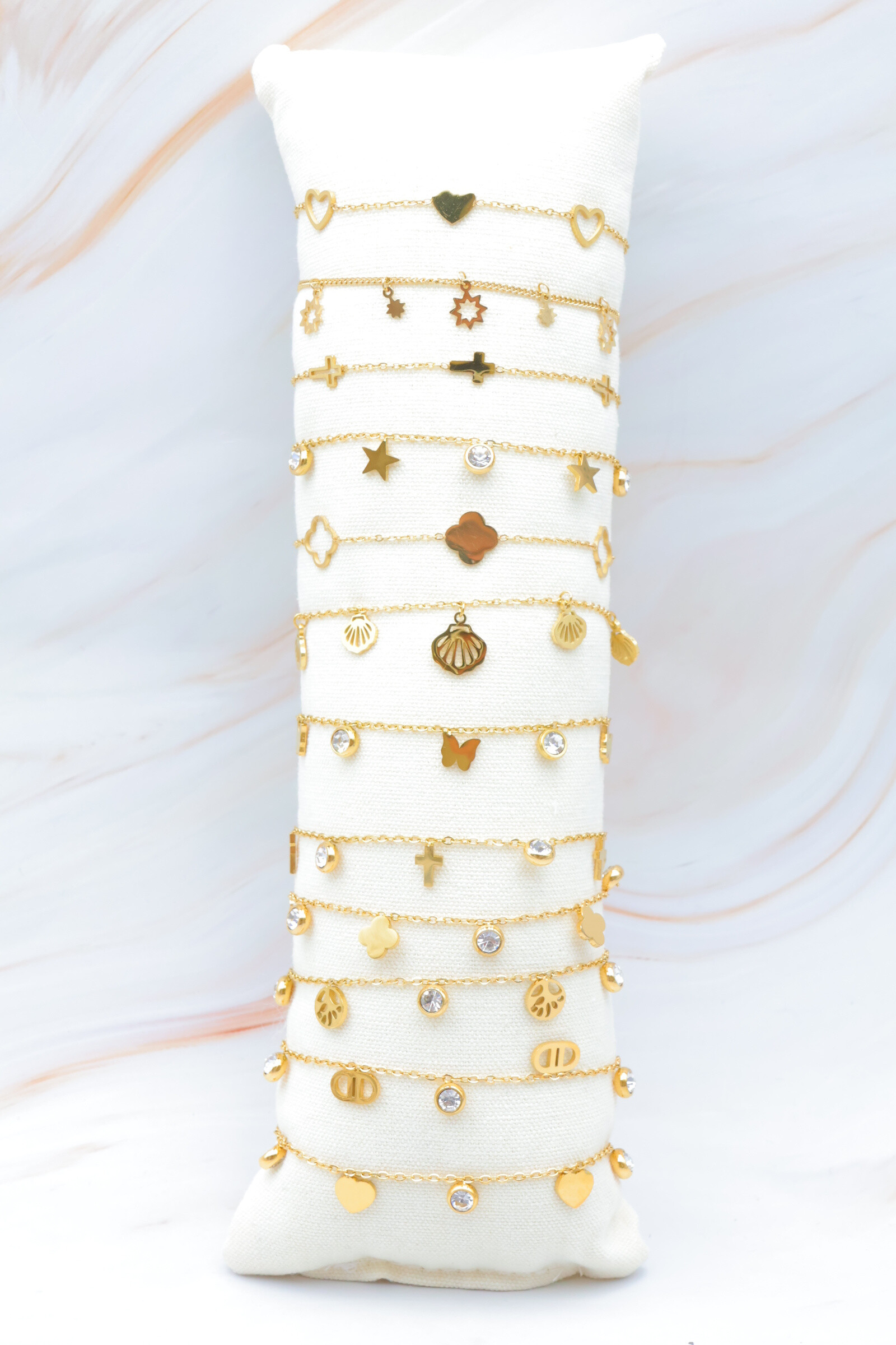 Grossista Bijoux Mystères - Set di 12 braccialetti in acciaio inossidabile con cuscino incluso