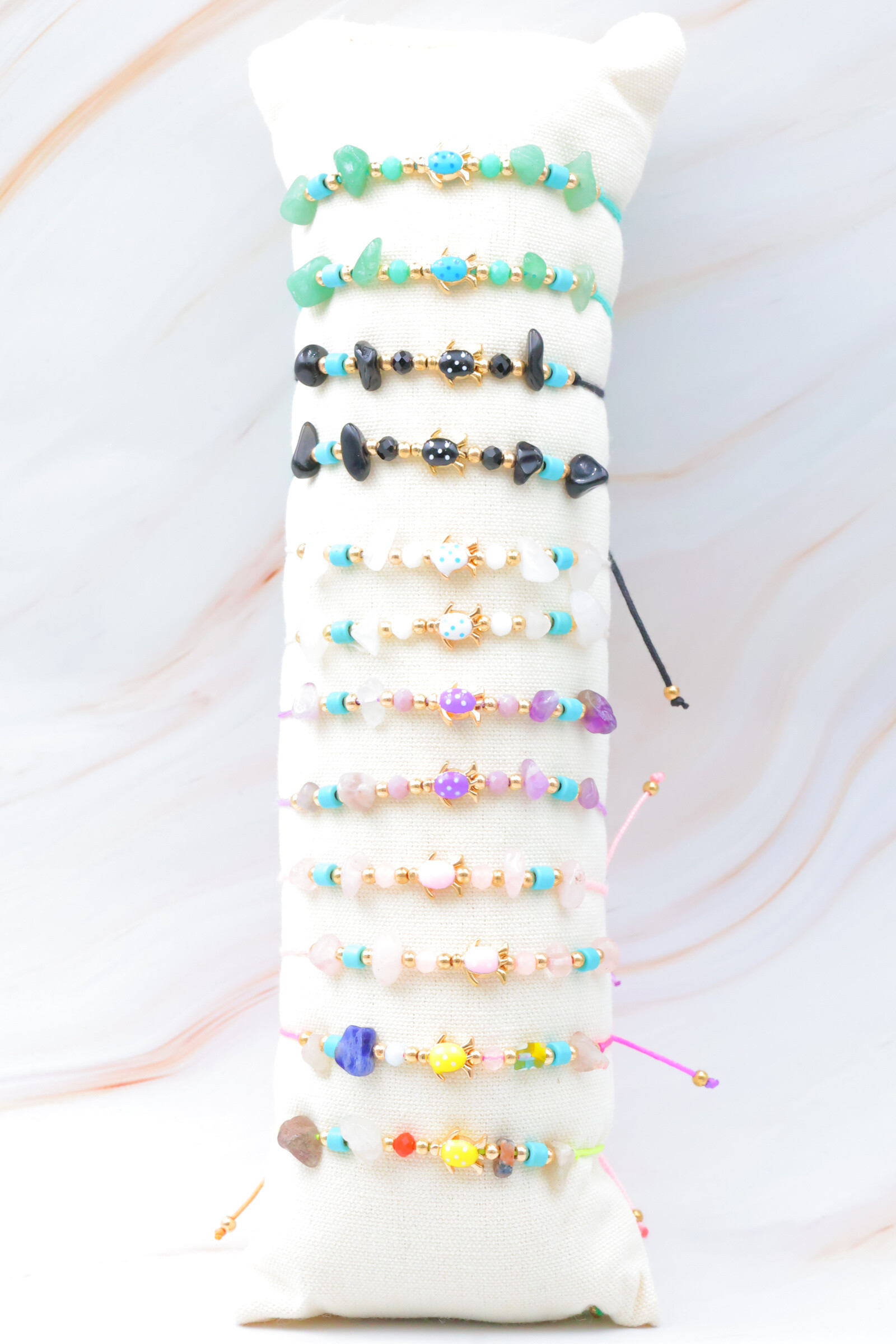 Grossista Bijoux Mystères - Set di 12 bracciali in acciaio inossidabile con cuscino incluso