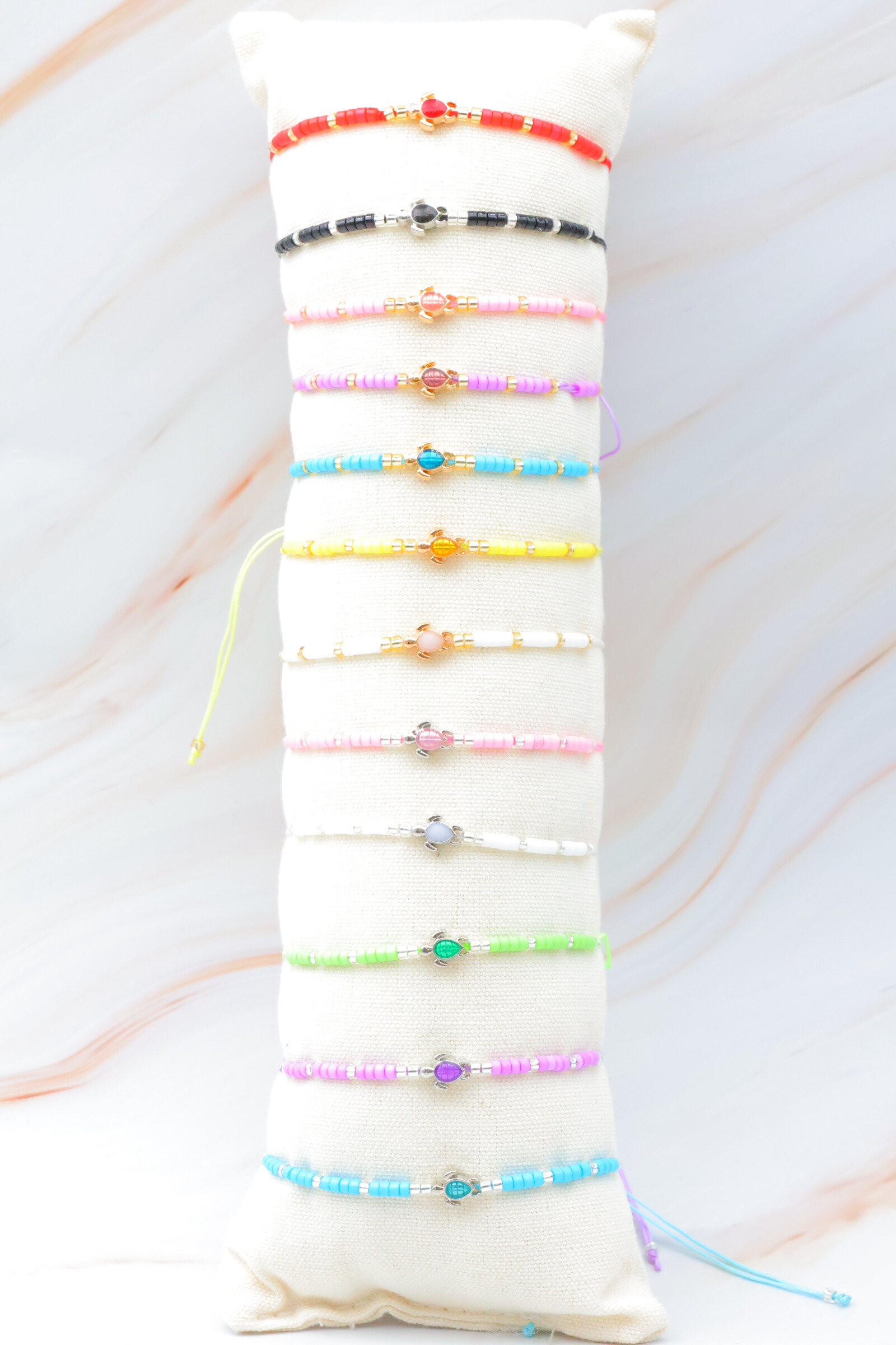 Grossista Bijoux Mystères - Set di 12 bracciali in acciaio inossidabile con cuscino incluso