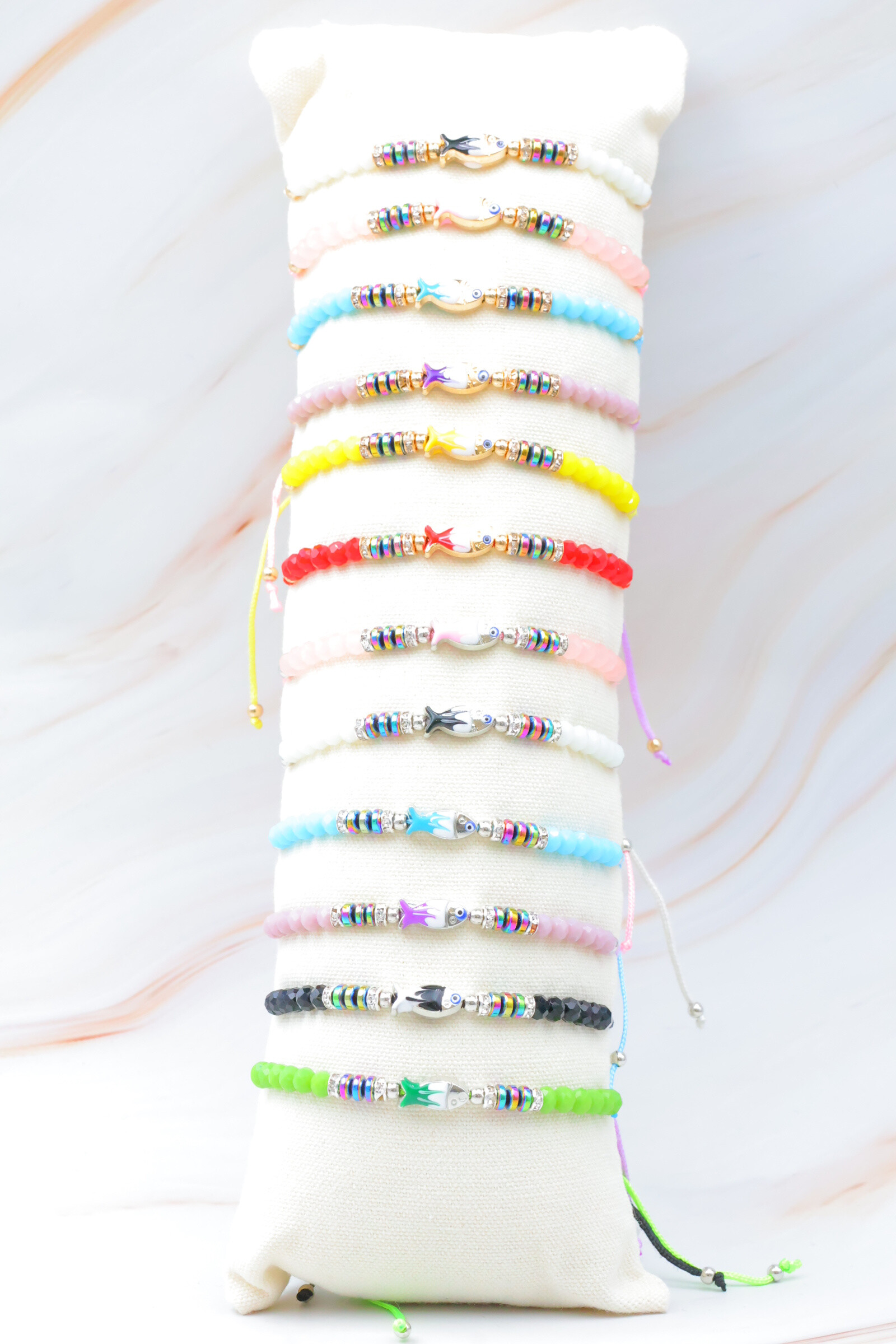 Grossista Bijoux Mystères - Set di 12 bracciali in acciaio inossidabile con cuscino incluso