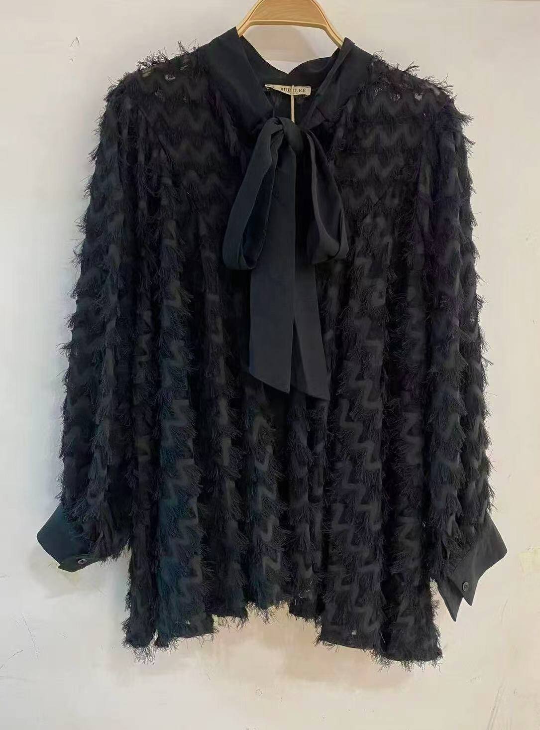 Blouse with a furry fabric tie.