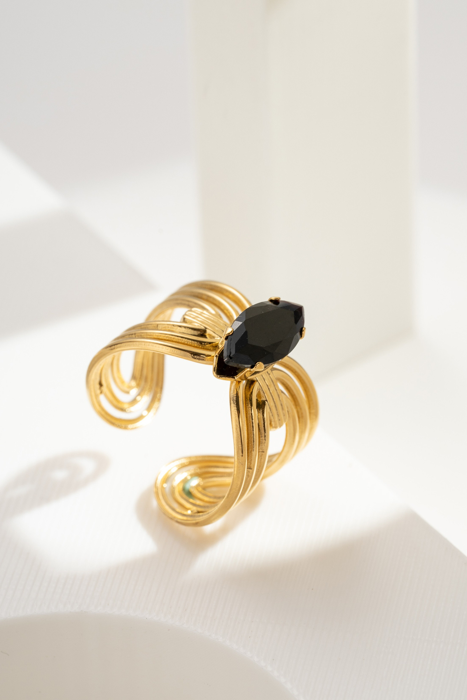Wholesaler COSMOS - Adjustable gold-plated steel ring with black marquise crystal and swirling pattern