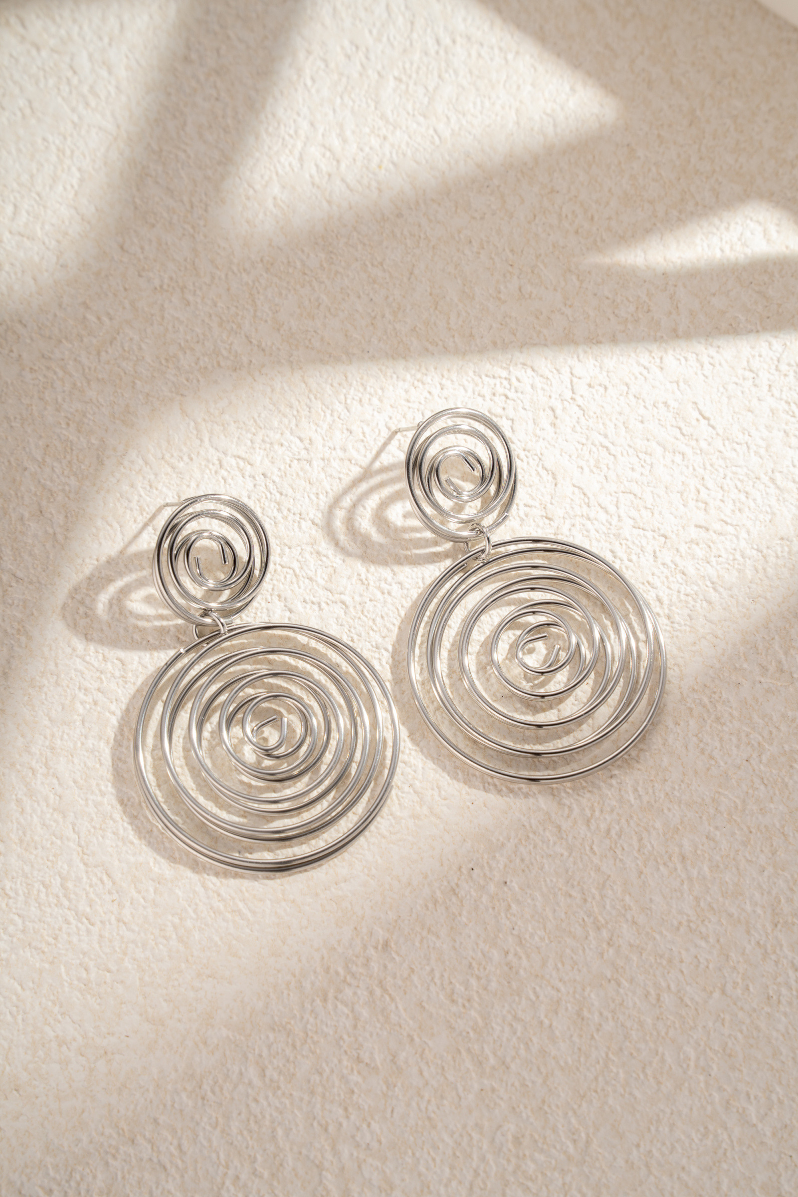 Wholesaler COSMOS - Double spiral drop earrings in stainless steel