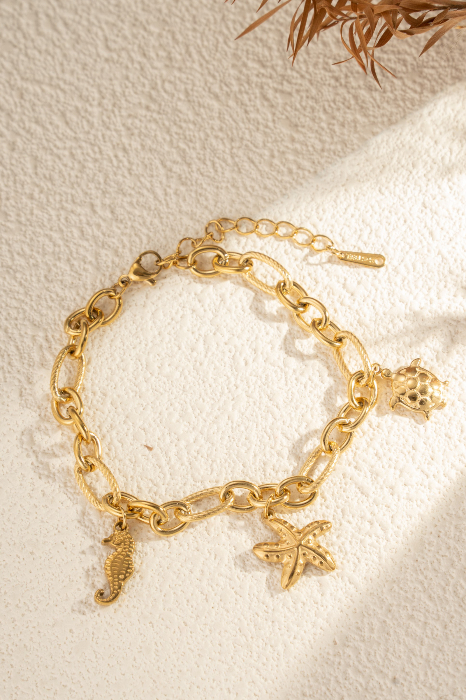 Mayorista COSMOS - Pulsera dorada con charms marinos caballito de mar estrella tortuga acero inoxidable elegante chic