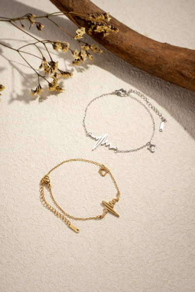 Wholesaler COSMOS - Set of two stainless steel bracelets in gold and silver with an elegant heartbeat design Wholesaler COSMOS - Set of two stainless steel bracelets in gold and silver with an elegant heartbeat design