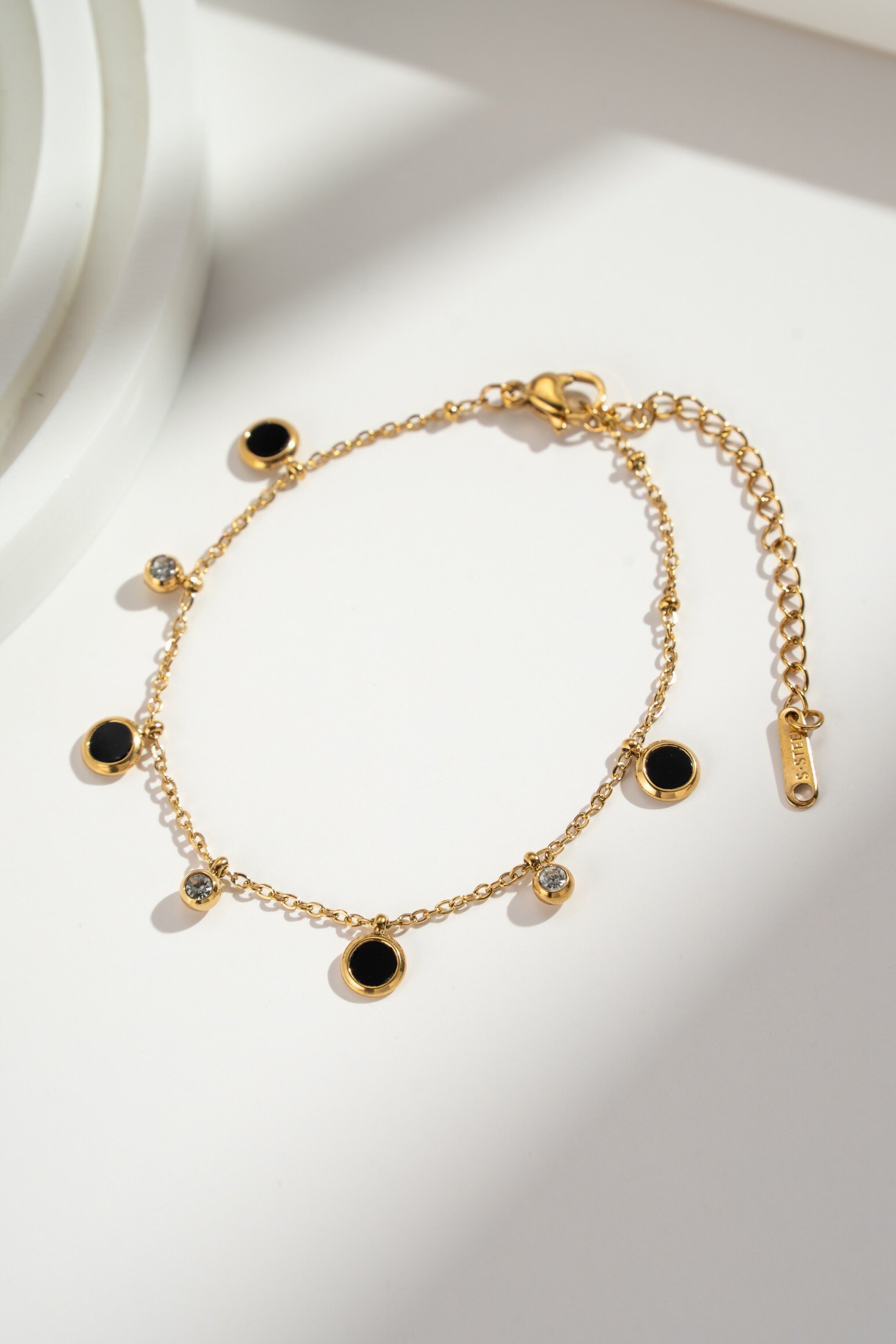 Wholesaler COSMOS - Bracelet with contrasting gold or silver accents, black charms, and sparkling crystals