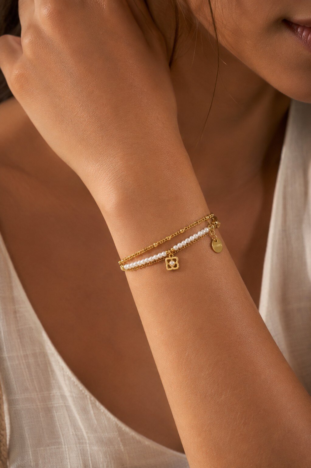 Wholesaler COSMOS - Gold bracelet with fine pearls, double chain, white flower charm, modern refined elegance