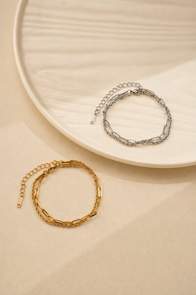 Wholesaler COSMOS - Set of 2 stainless steel bracelets in gold and silver with modern elegant twisted links Wholesaler COSMOS - Set of 2 stainless steel bracelets in gold and silver with modern elegant twisted links