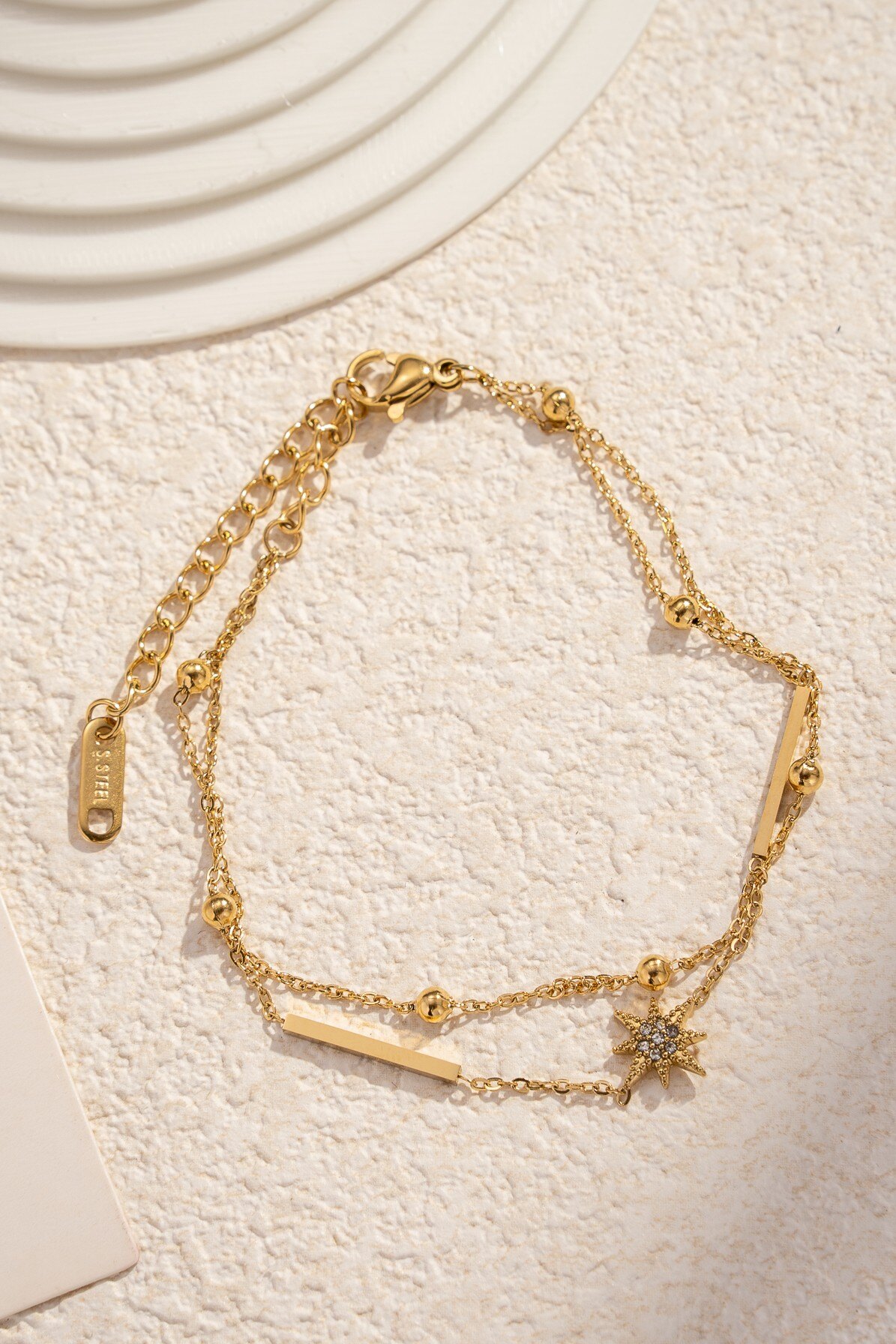 Grossiste COSMOS - Bracelet en acier inoxydable doré avec étoile strassée double tour