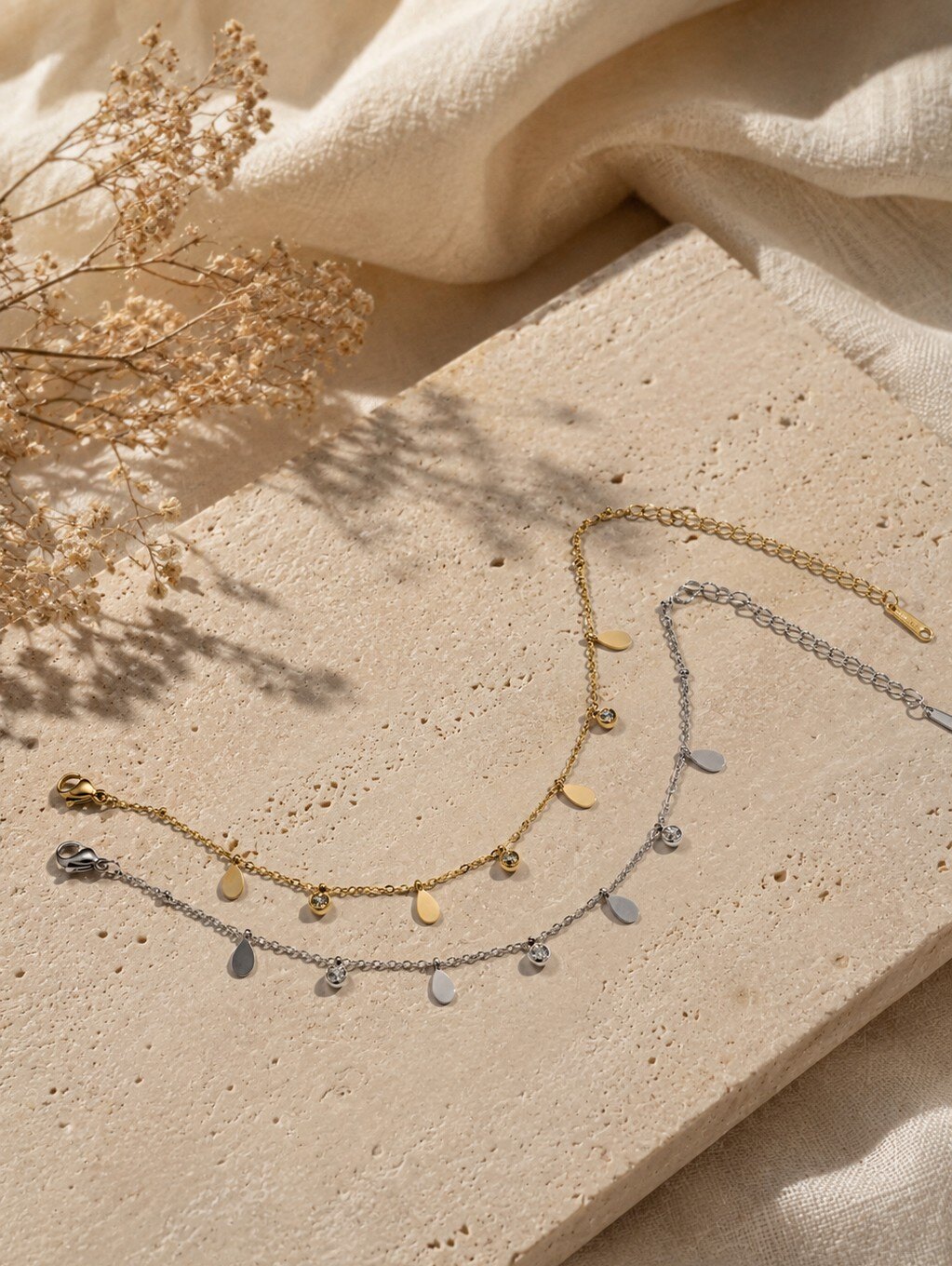 Wholesaler COSMOS - Set of 2 stainless steel bracelets in gold and silver with elegant drop and disc charms
