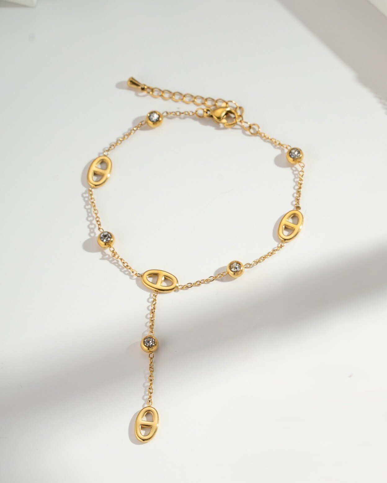 Wholesaler COSMOS - Women's gold-tone stainless steel bracelet with oval links, clear stones, charm, and adjustable elegant chain