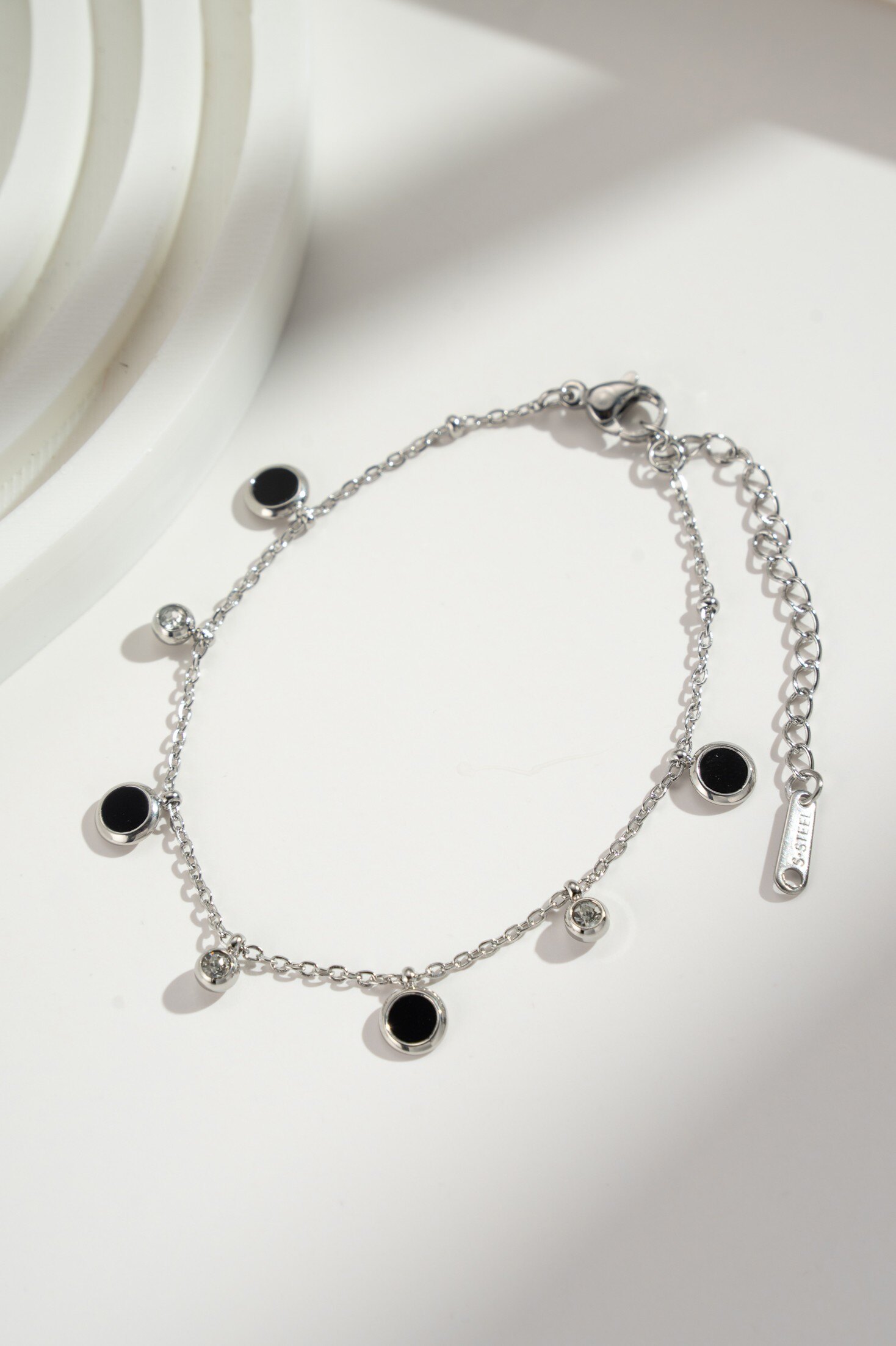 Wholesaler COSMOS - Bracelet with contrasting gold or silver accents, black charms, and sparkling crystals