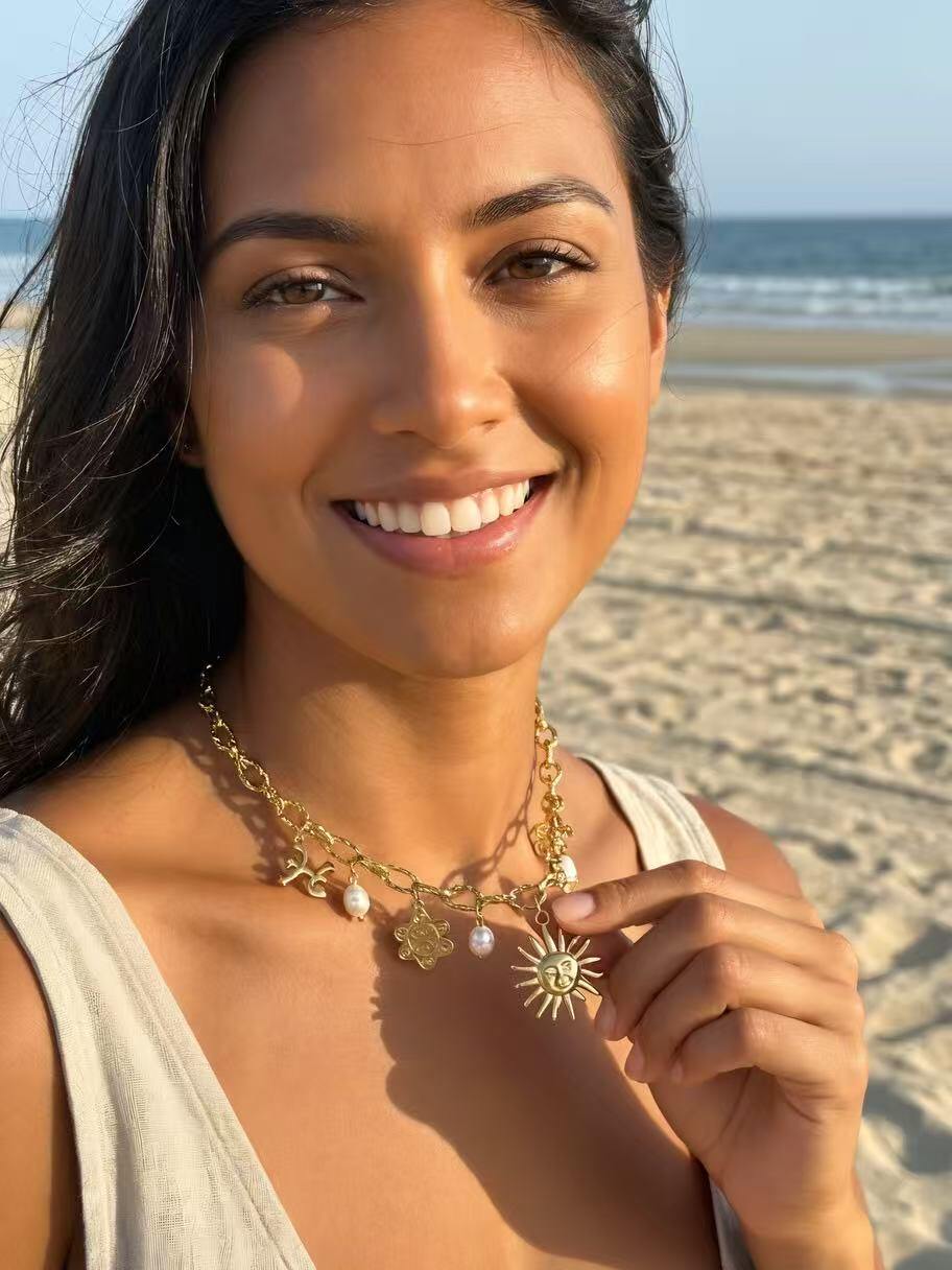 Wholesaler COSMOS - Golden sun charm necklace in stainless steel with bohemian symbols and beads, elegant and trendy for women