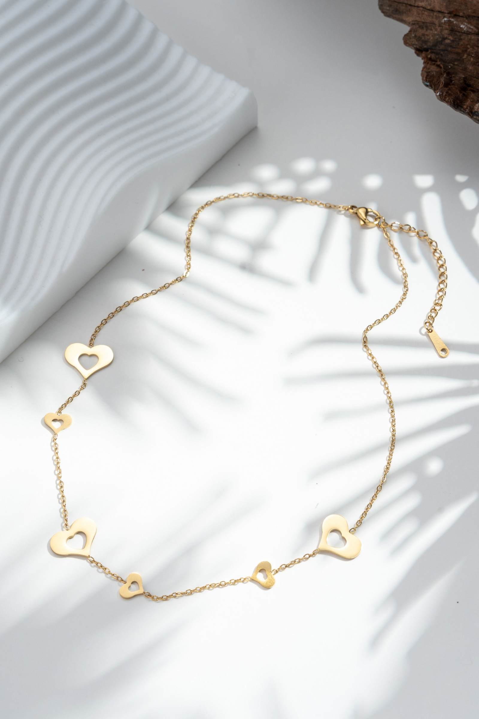 Wholesaler COSMOS - Openwork heart necklace in gold stainless steel — minimalist tenderness and refined shine
