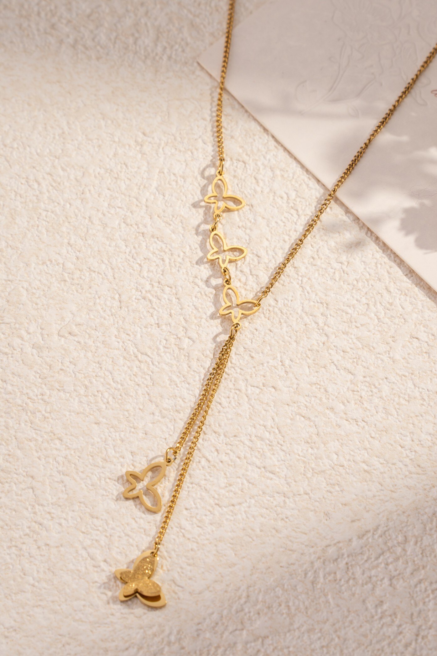 Wholesaler COSMOS - Golden flight necklace, openwork and solid butterflies, fine and poetic steel
