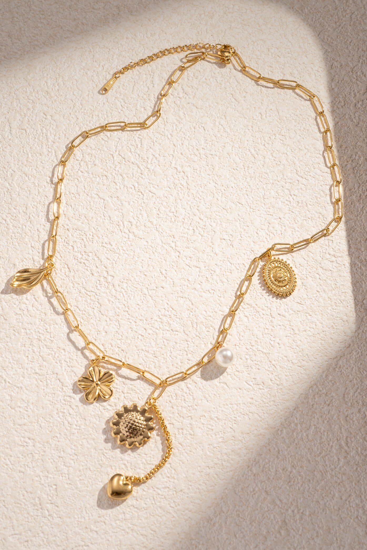 Wholesaler COSMOS - Trendy women's gold charm necklace in stainless steel with pearl, leaf, flower, heart, and medal