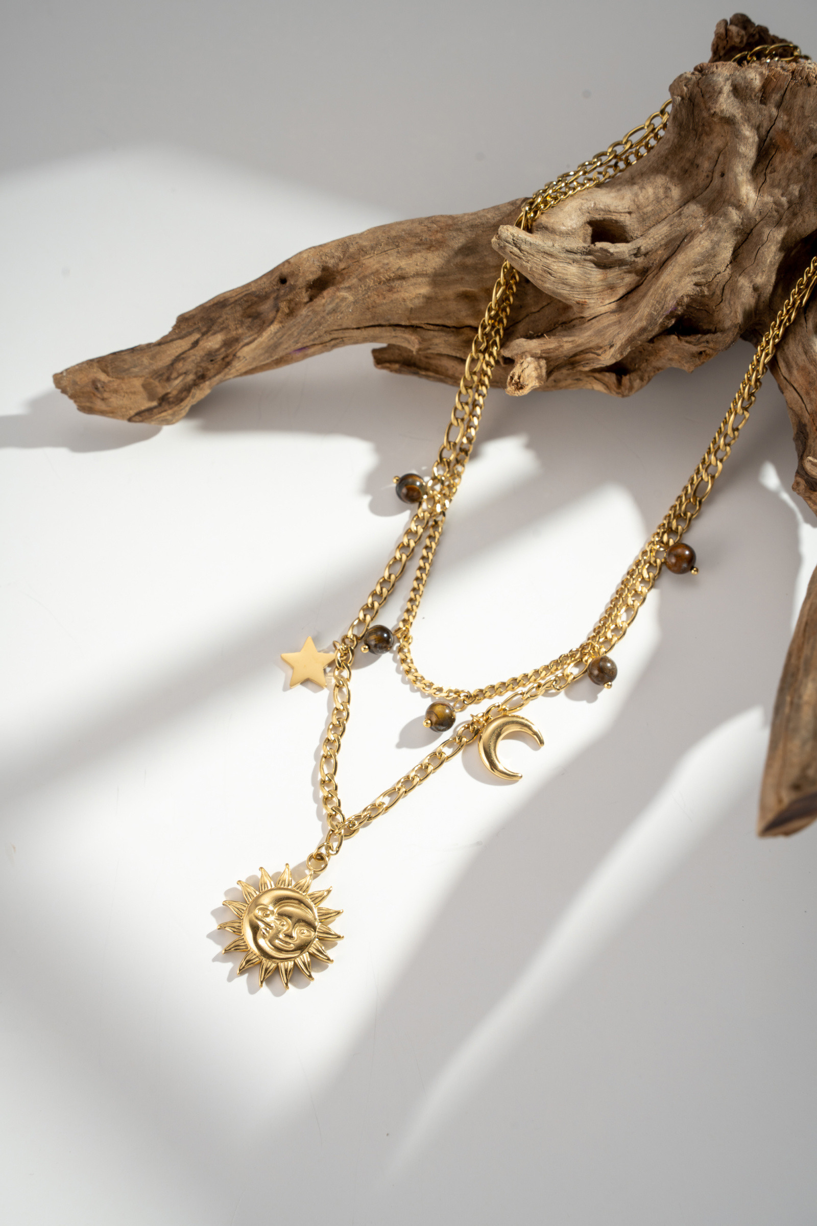 Wholesaler COSMOS - Golden stainless steel celestial multi-charm necklace with sun, moon, star, and beads
