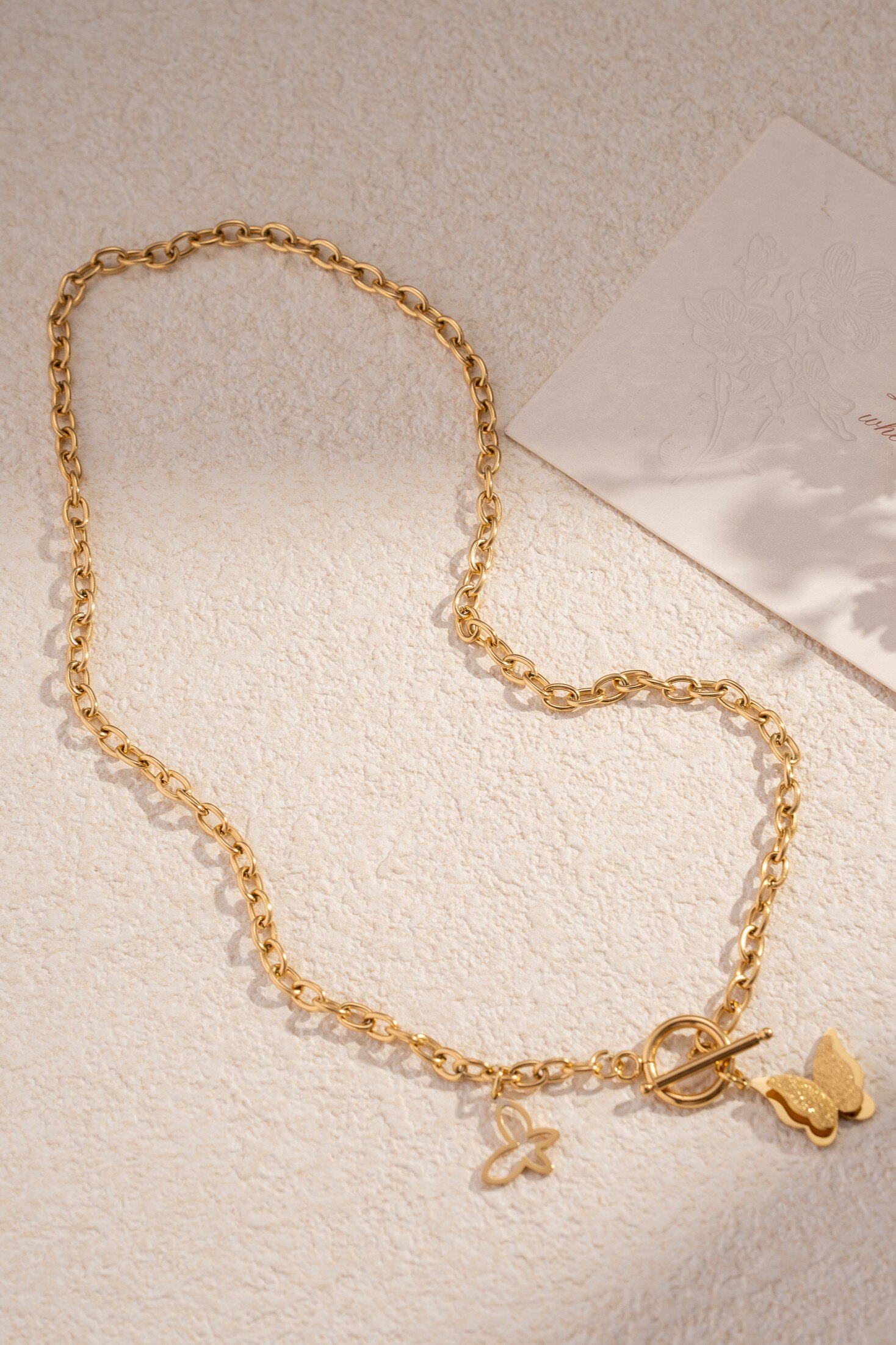 Wholesaler COSMOS - Golden butterfly necklace with floral pattern, fine steel and delicate charm