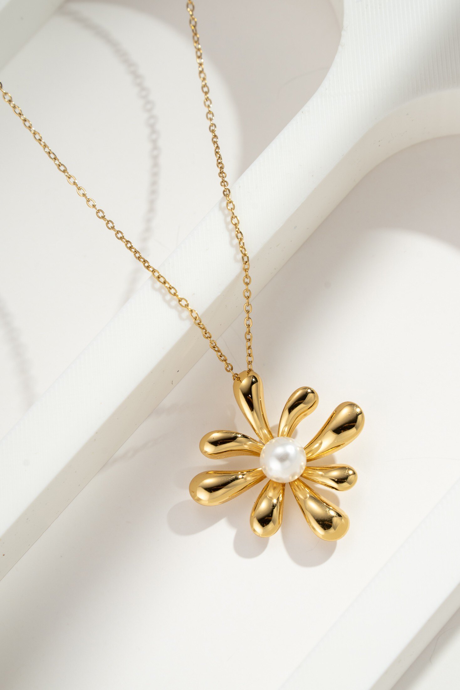 Grossiste COSMOS - Collier fleur dorée élégante orné de perle blanche, bijou raffiné féminin chic