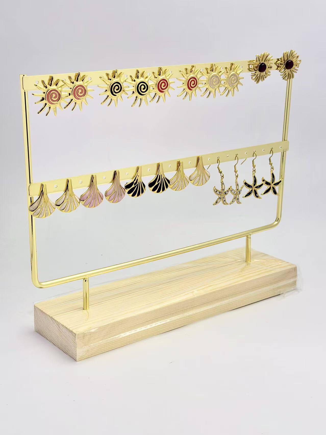 Mayorista COSMOS - Juego de 11 pares de pendientes de acero inoxidable con exhibidor de sol, concha y estrella de mar