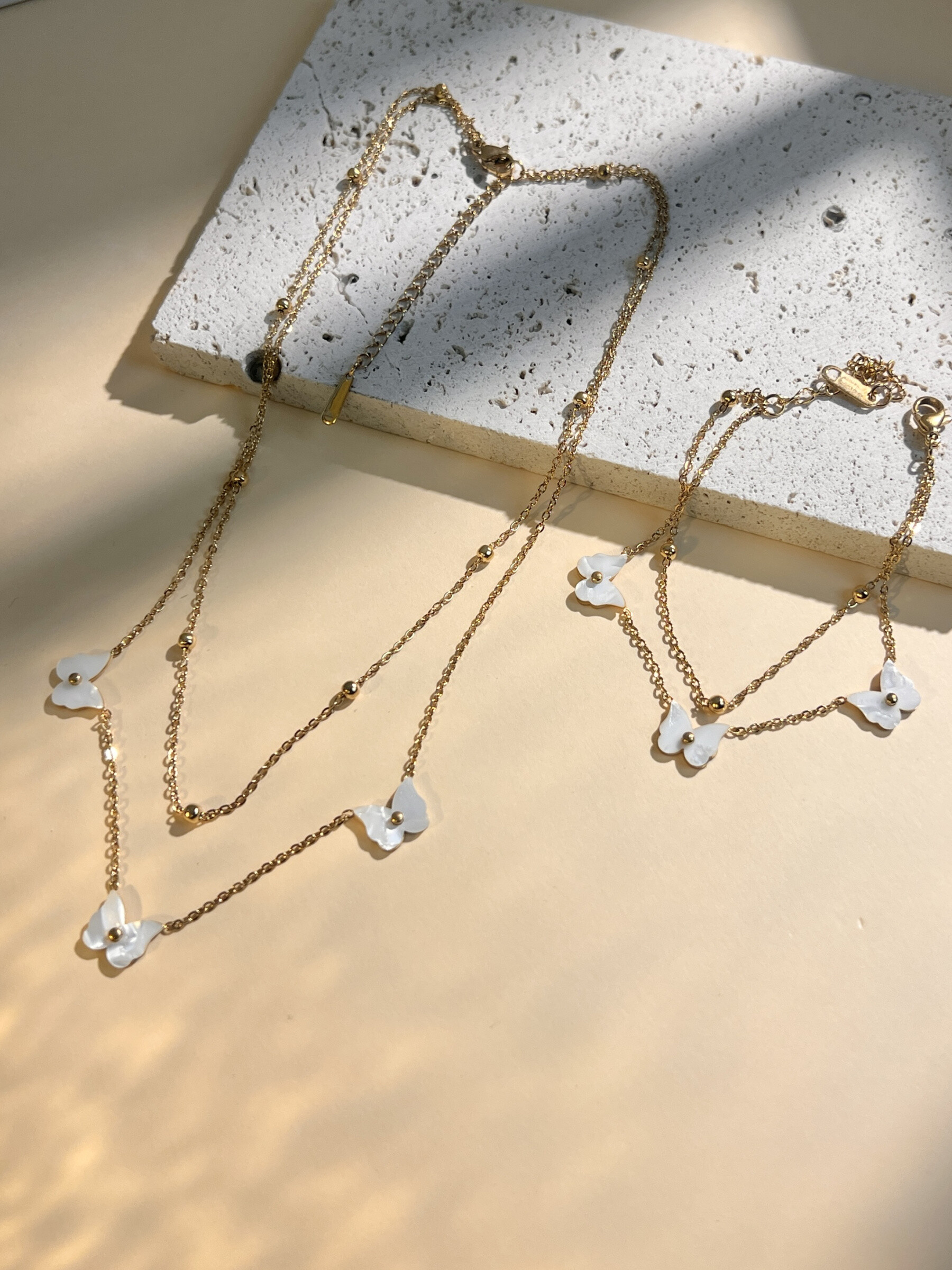Grossiste COSMOS - Parure collier et bracelet double tour papillon en nacre