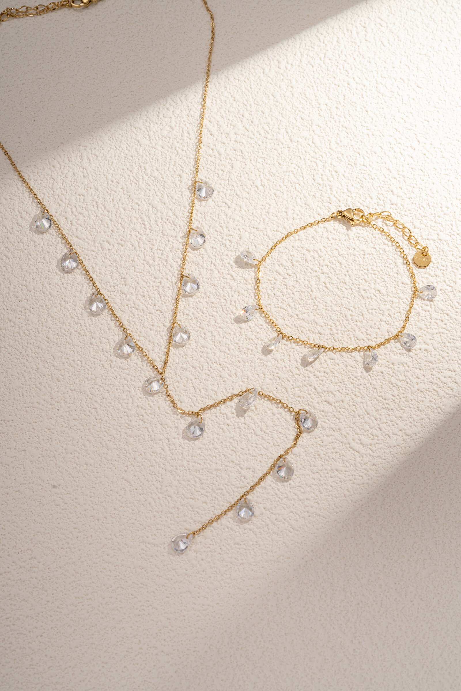 Grossiste COSMOS - Parure collier en Y et bracelet avec perle goutte cristal blanc en acier