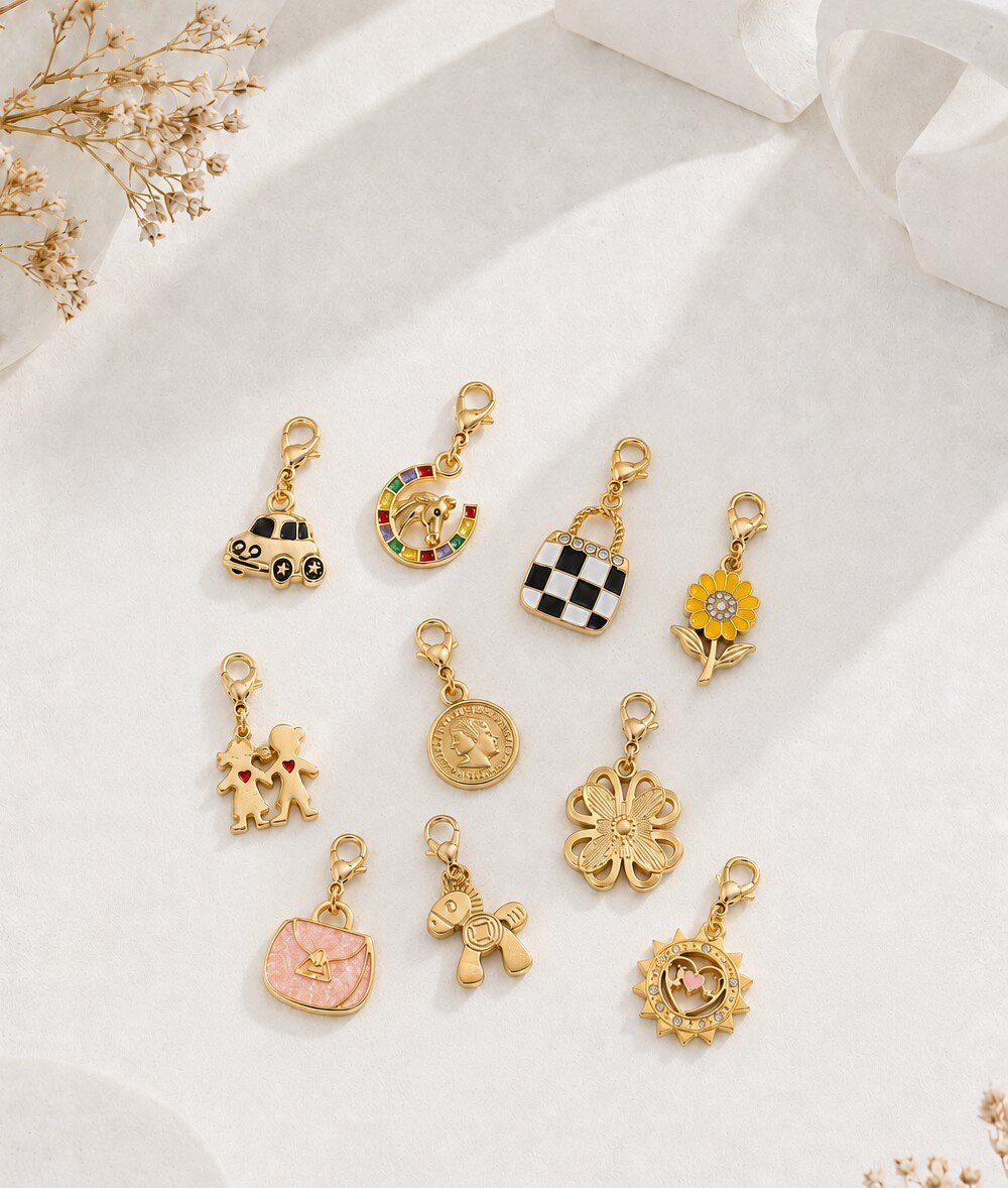 Grossista COSMOS - Set di 10 charm dorati con motivi fantasiosi, natura, moda e simboli colorati