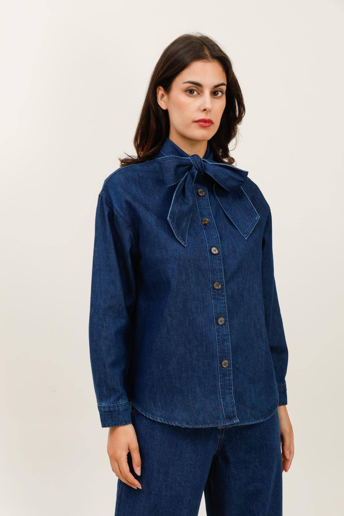 Denim shirt with tie collar Soft denim straight shirt, adorned with a large tie collar for a feminine and elegant touch. Button closure all the way down, buttoned cuffs, and long sleeves. An timeless piece with a couture twist, balancing classic and modern.