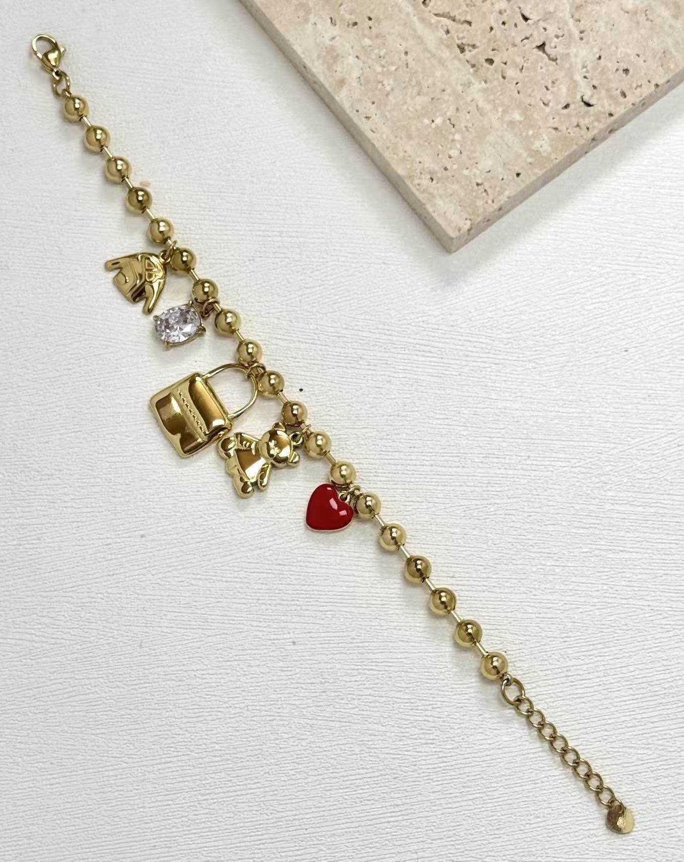 Grossista Eclador Bijoux - Bracciale in acciaio inossidabile, decorato con diversi piccoli pendenti circolari.