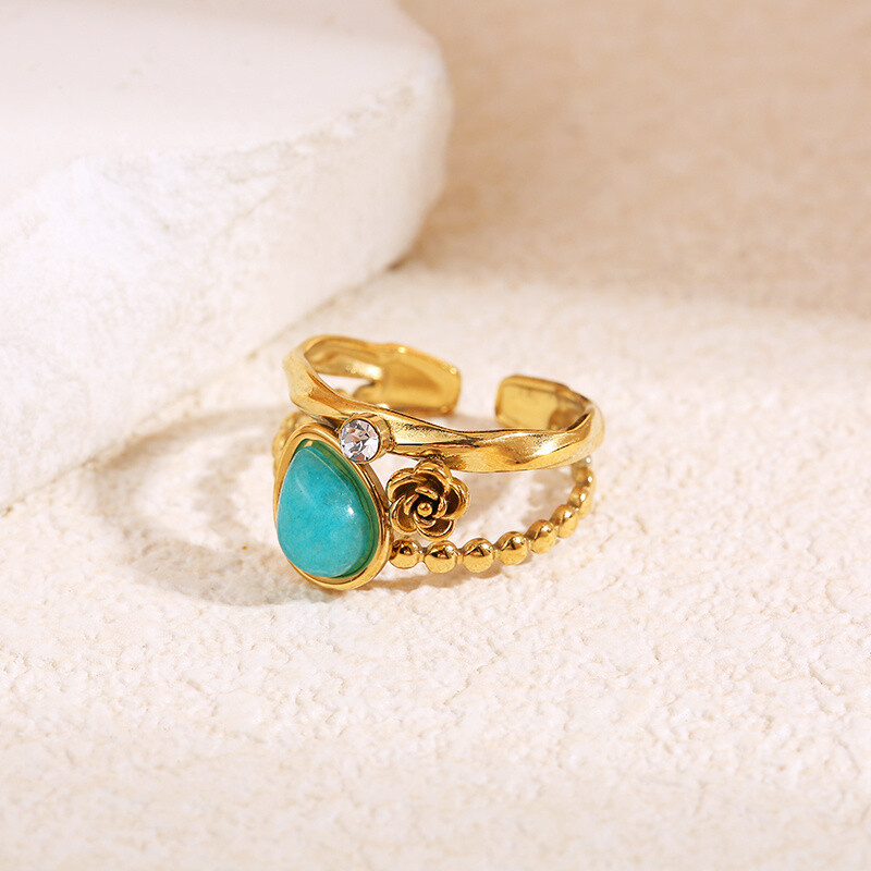 Grossista Eclat Paris - Anello dorato con fiore, strass e pietra a goccia blu