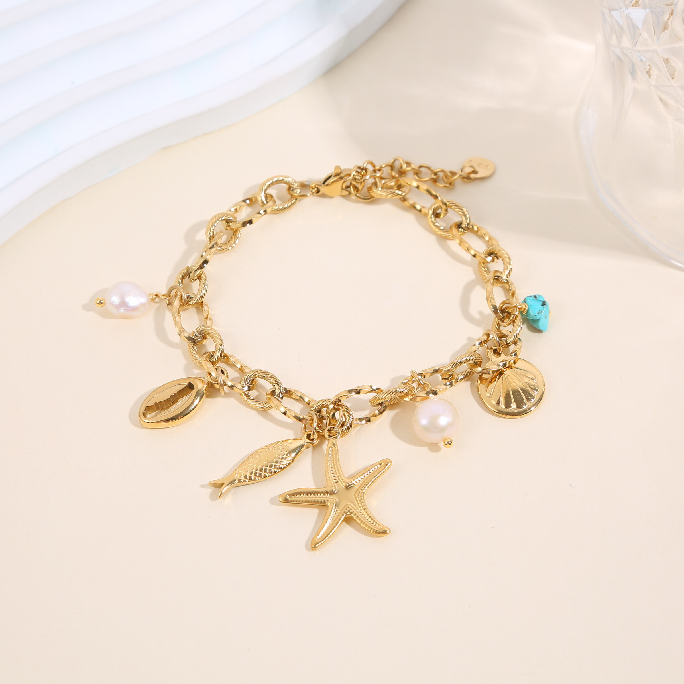 Grossista Eclat Paris - Bracciale maglie ciondoli stella marina pesce conchiglia