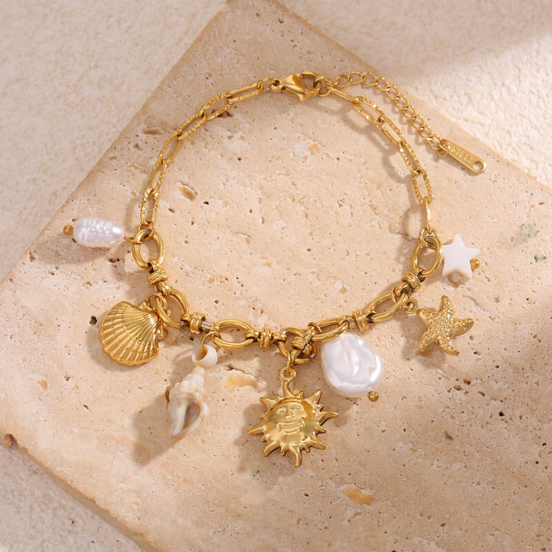 Wholesaler Eclat Paris - Golden chain bracelet with marine charms decorated with shells