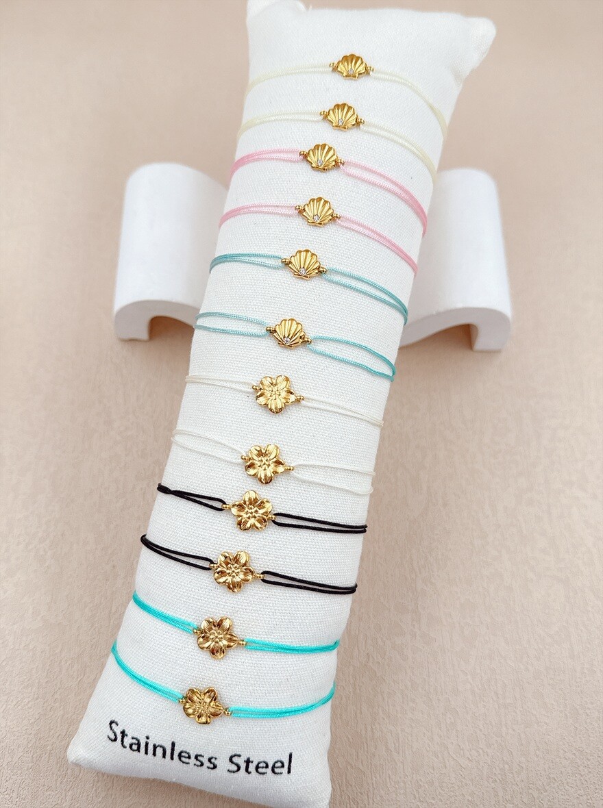 Grossista Ella Ella - SET DI 12 BRACCIALETTI IN ACCIAIO INOX SU CUSCINO