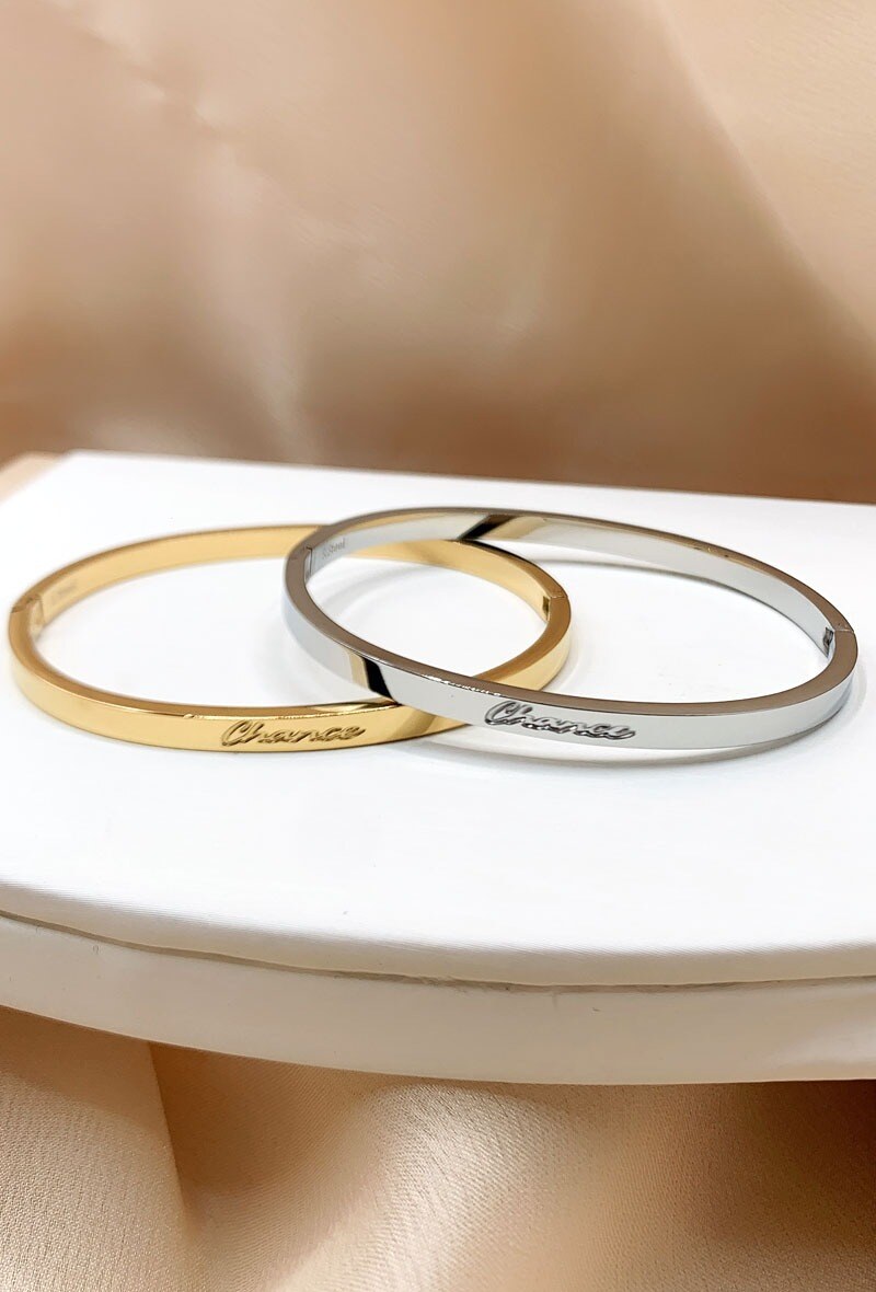 Wholesaler Emily - Closed steel bangle with engraved message LUCK