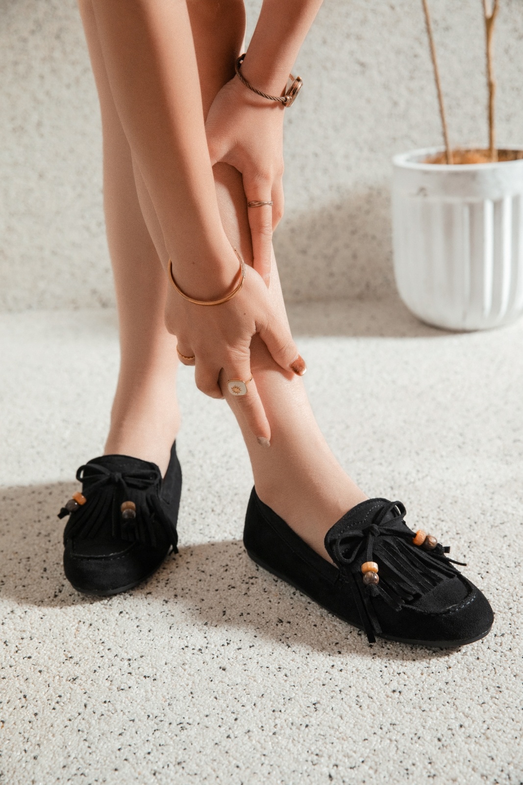 flat mule with fringes and a small bow.