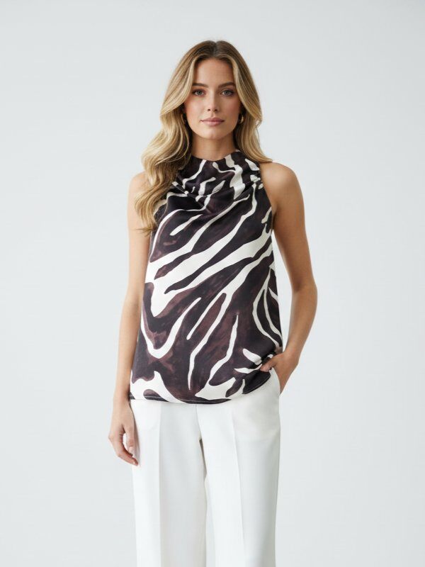 Mayorista J&H Fashion - Top de poliéster con estampado de cebra, botón elegante en el cuello trasero, ideal para la primavera, fabricado en China. Perfecto para darle vida a tu armario de verano.
