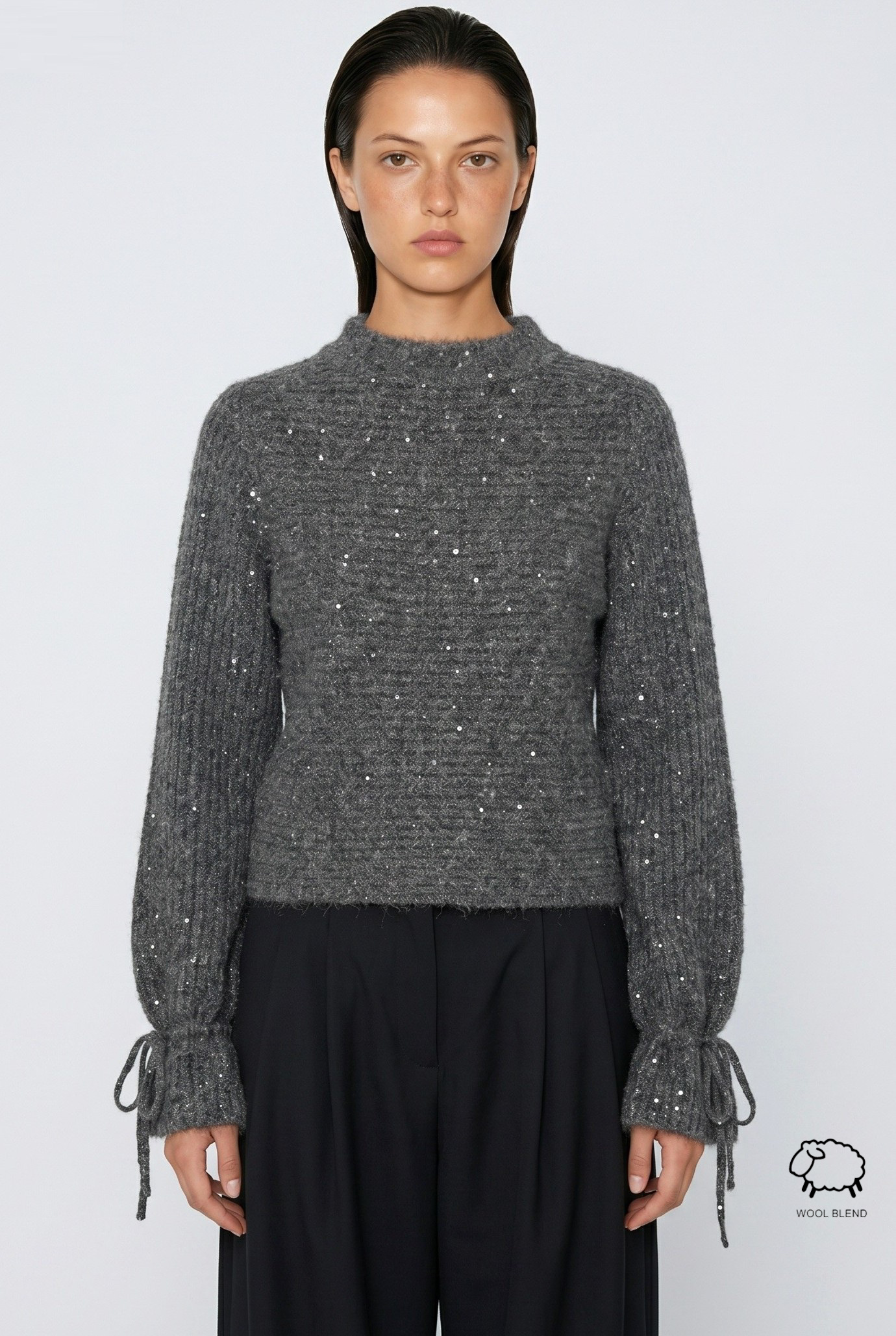 Grossiste JAMILLA - Pull d'hiver en laine mélangée noir avec point lumineux, paillettes et poignets froncés en nœud