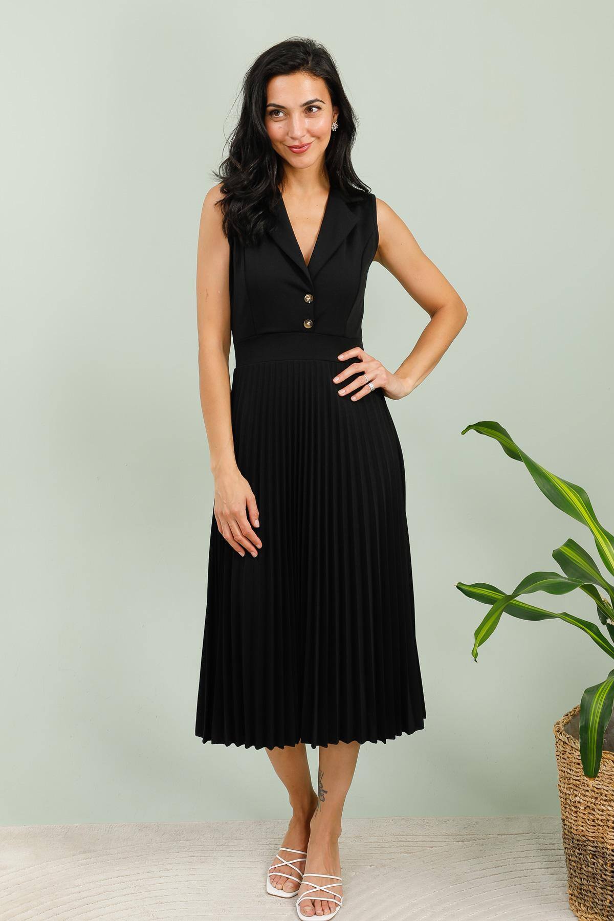 Sleeveless Pleated Dress – Timeless Elegance
This dress is the perfect embodiment of minimalist chic. Ideal for the office, a dinner, or a ceremony, it combines structure and fluidity in a sophisticated and flattering design.

🔸 Design:

Sleeveless blazer-style top with a lapel collar

Two golden buttons on the bust for an elegant touch

Defined waist that enhances the silhouette

Pleated midi skirt for a fluid and dynamic drape

Mid-calf length, perfect for any occasion

🔸 Details:

V-neckline for a feminine look

Structured top, harmonious contrast with the lightness of the pleats

🔸 Material:

Fluid and comfortable fabric, resists wrinkles

Composition: 95% polyester, 5% elastane

🔸 Sizes:

Available from S to XXL

💡 Style tip: Pair it with heeled sandals for a dressy outfit or with white sneakers for a more casual-chic look.