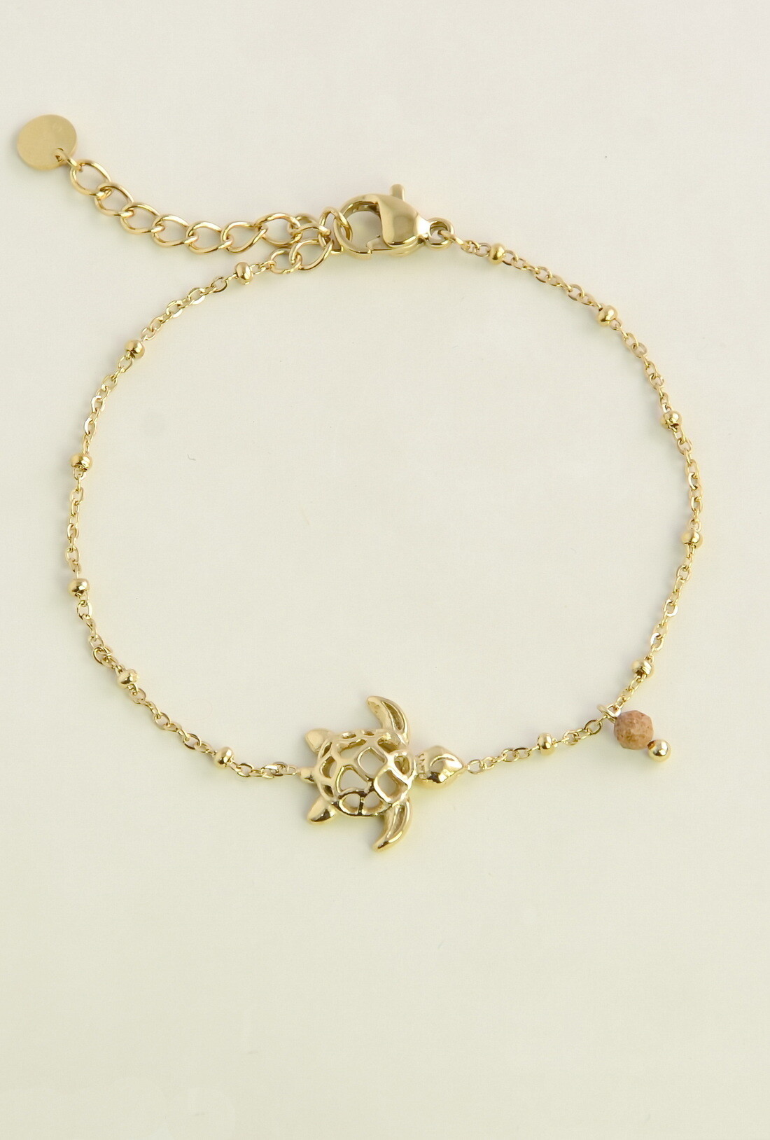 Grossiste LILY CONTI - Bracelet doré en acier inoxydable, pierres facettées et tortue